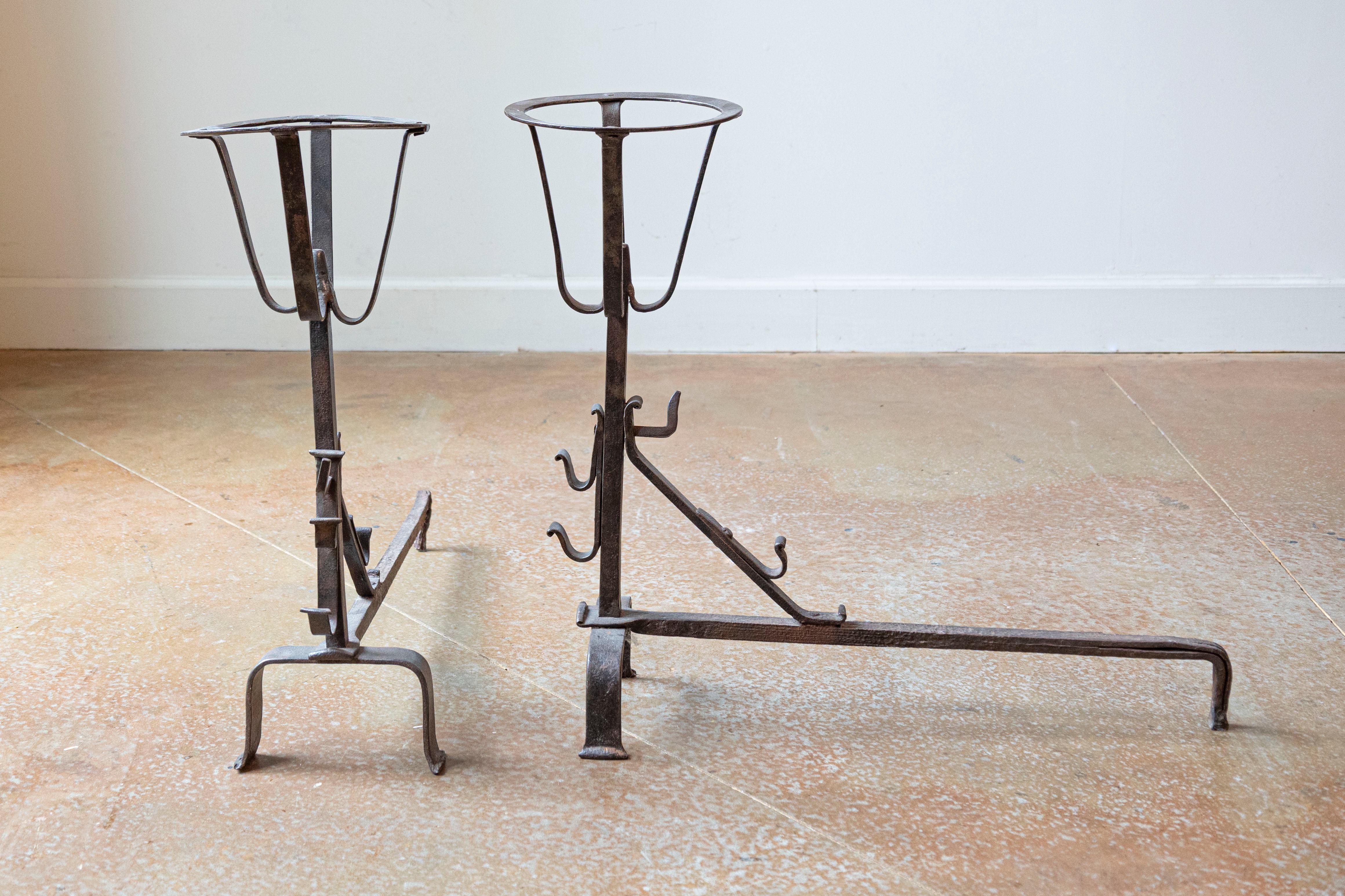 A pair of French Napoléon III period andirons from the late 19th century. Created in France at the end of Emperor Napoléon III's reign to hold flaming firewood slightly above the firebox floor, each of this pair of andirons features a circular