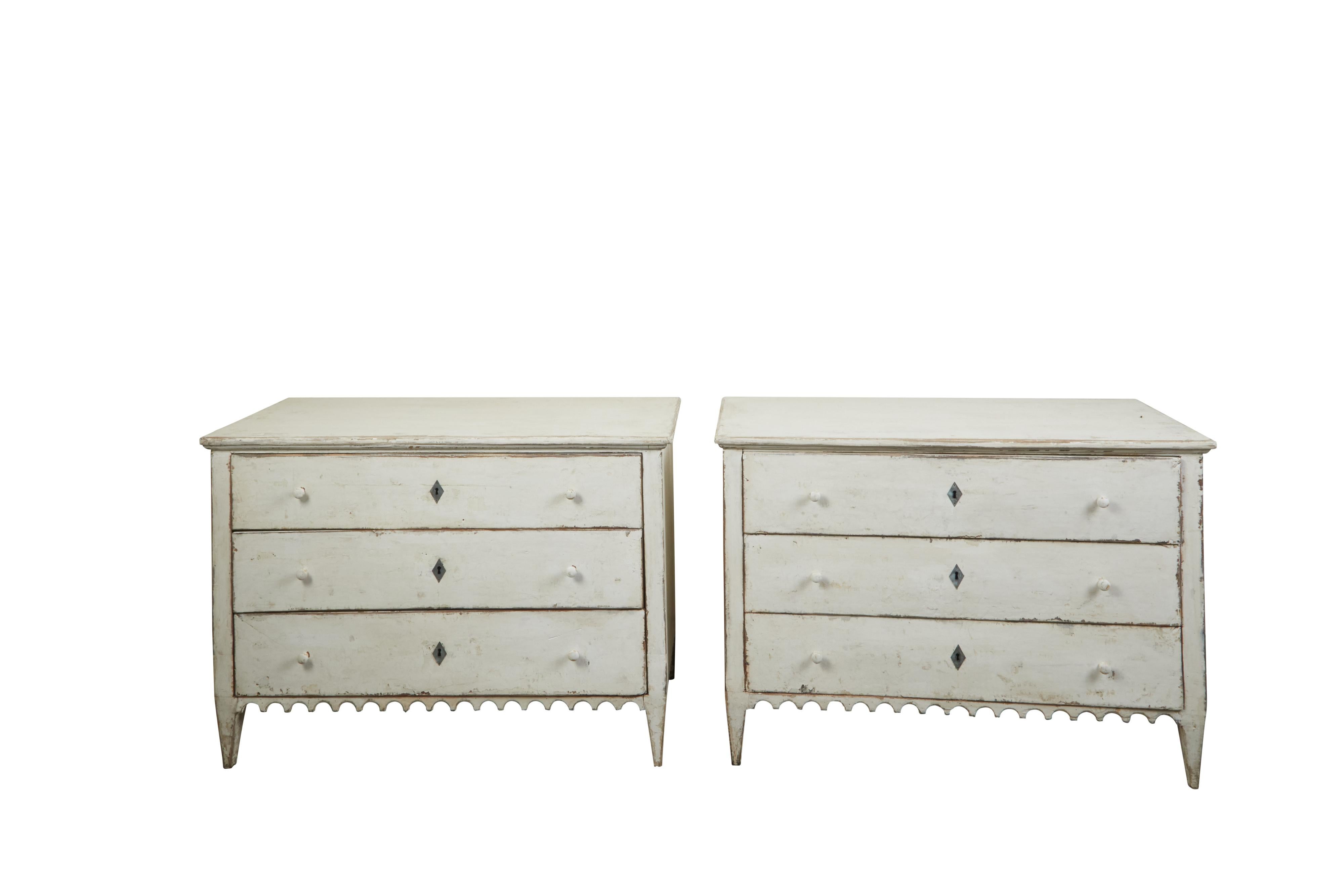 A pair of French three-drawer commodes from the late 19th century, with new paint and scalloped skirt. Created in France during the third quarter of the 19th century, each of this pair of painted commodes features a rectangular top sitting above a