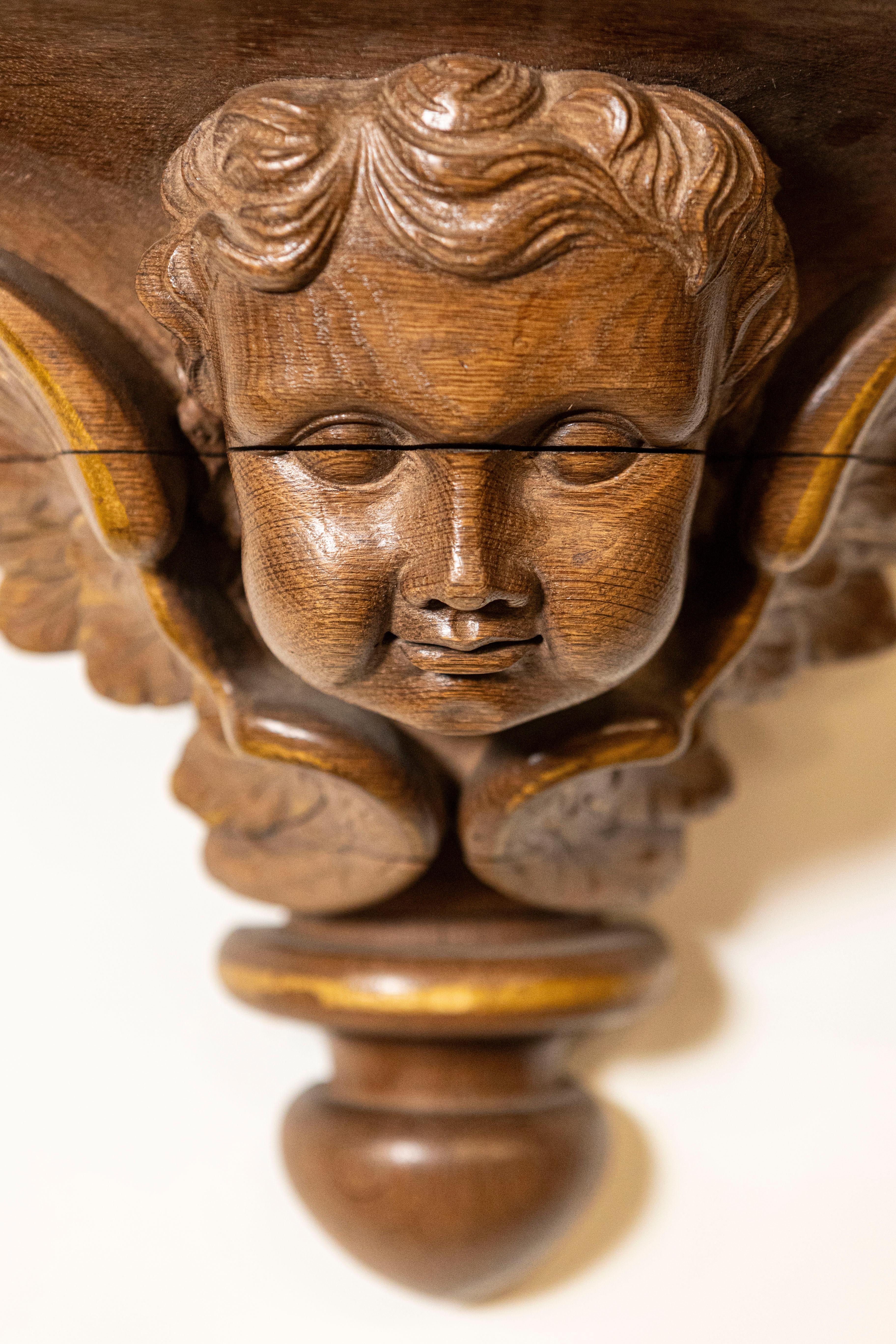 19th Century Pair of French 1880s Carved Walnut Brackets with Cherubs and Faux Marble Tops For Sale