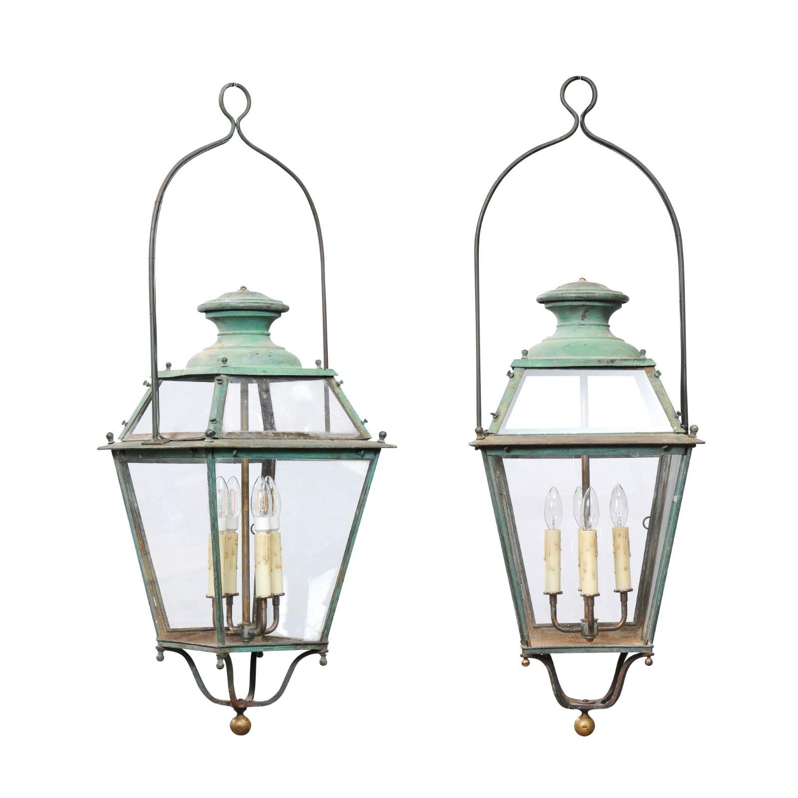 A pair of French copper four-light lanterns circa 1890 with Verdigris patina and glass panels. Embrace the charm of old-world elegance with this pair of French copper four-light lanterns, circa 1890. Each lantern showcases a Verdigris patina that