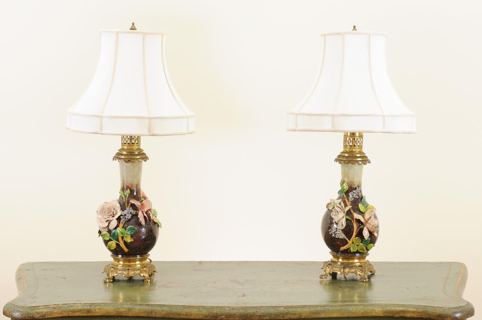 A pair of French majolica vases from the late 19th century made into table lamps. Created in France during the last decade from the 19th century, each of this pair of majolica vases features a lovely raised décor depicting pink roses and their green
