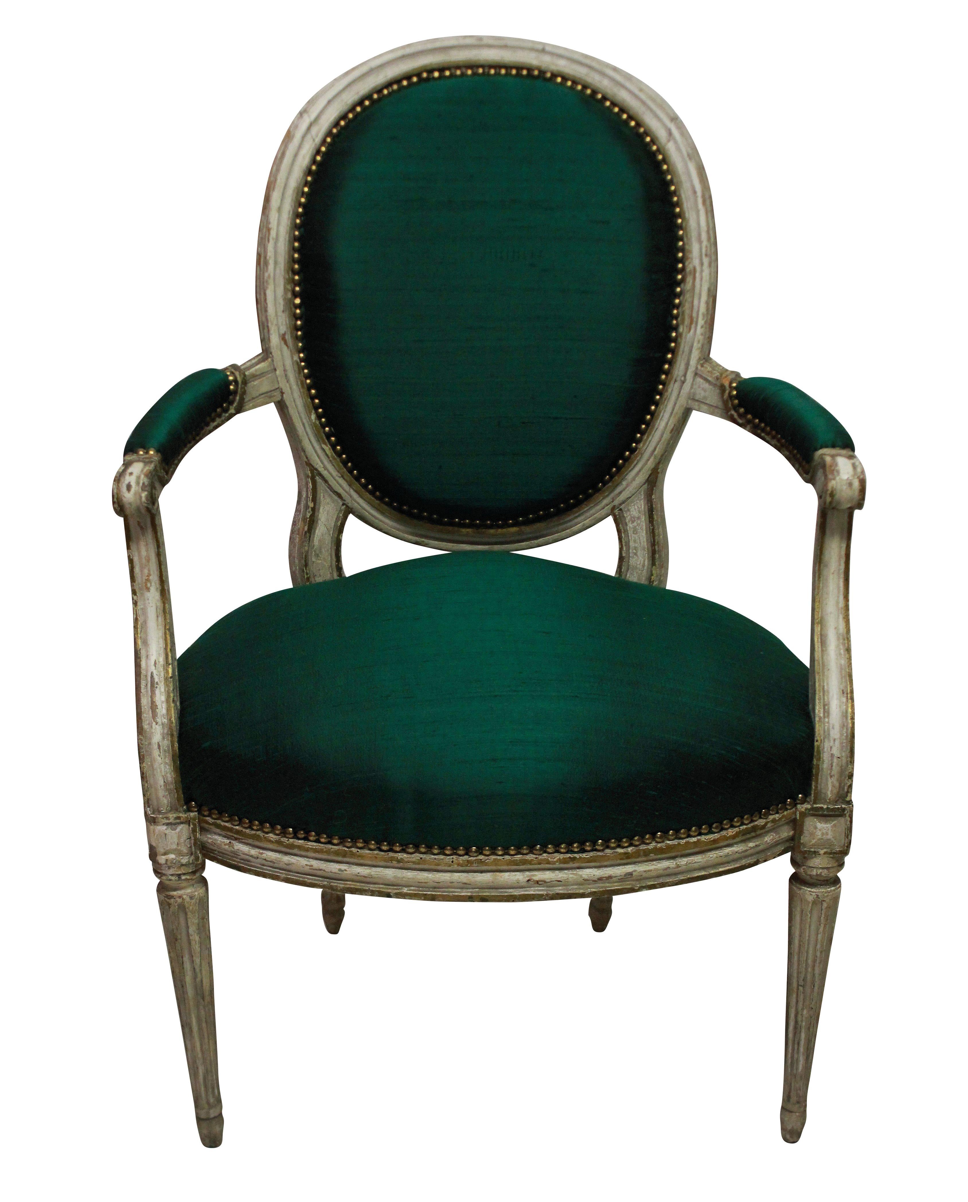 A pair of French 18th century painted armchairs. In their original condition, newly upholstered in emerald silk.

  