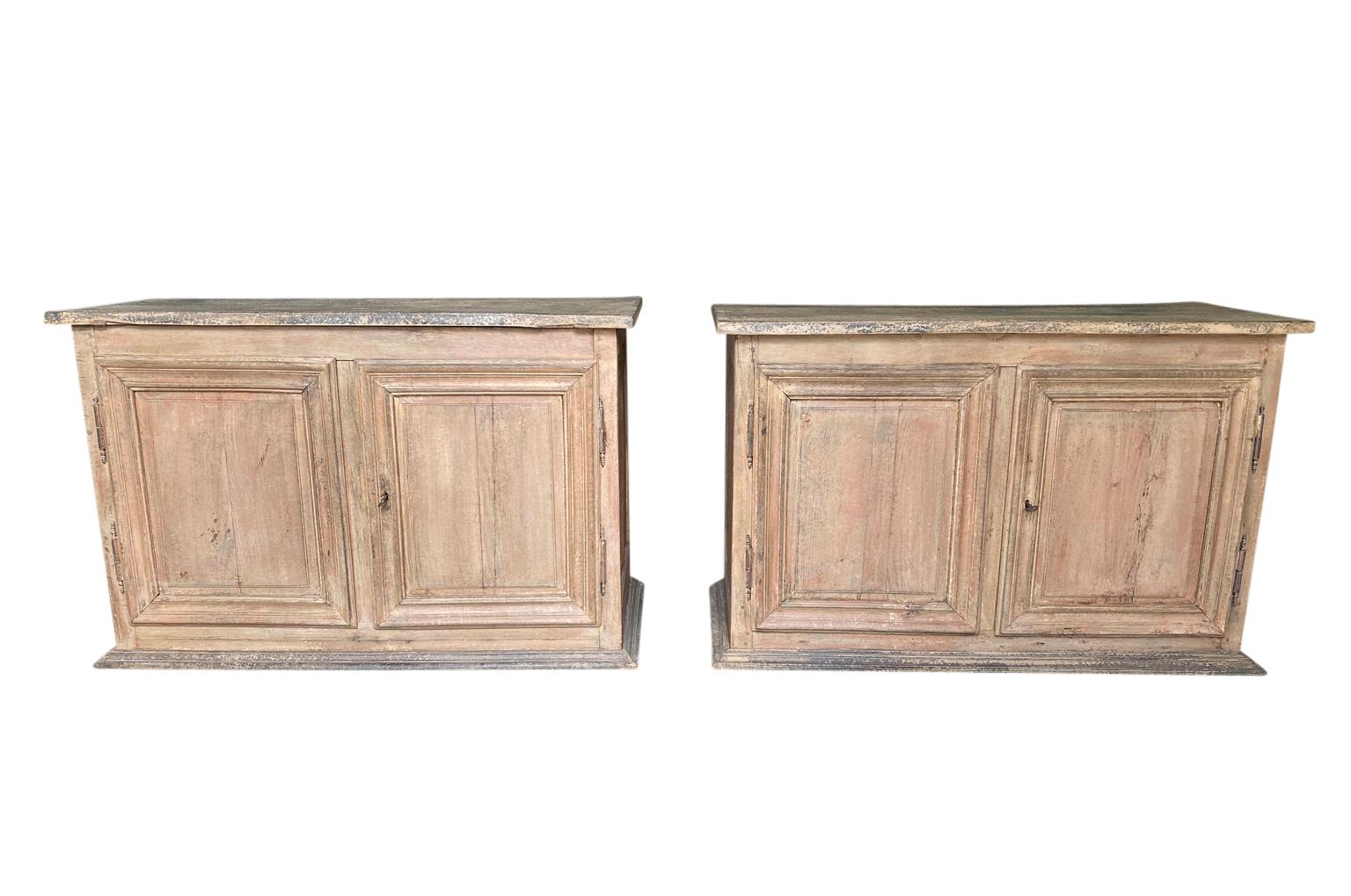 A very lovely pair of 18th century buffets from the Provence region of France. Handsomely constructed from painted oak with molded door panels resting on plinth bases. Wonderful finish and patina.