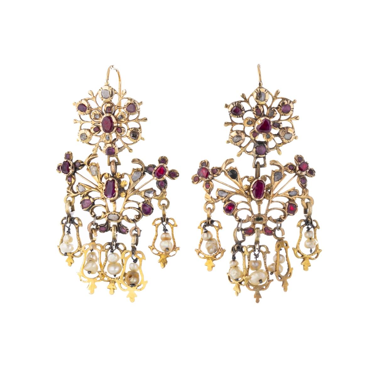 Pair of French 18th century gold earrings
in fenestrated gold earring with pendant elements, studded with rubies, diamonds and jellyfish. Remarked with French warranty marks 'ET', post 1838'. Signs of use, restorations and earring hooks open, put