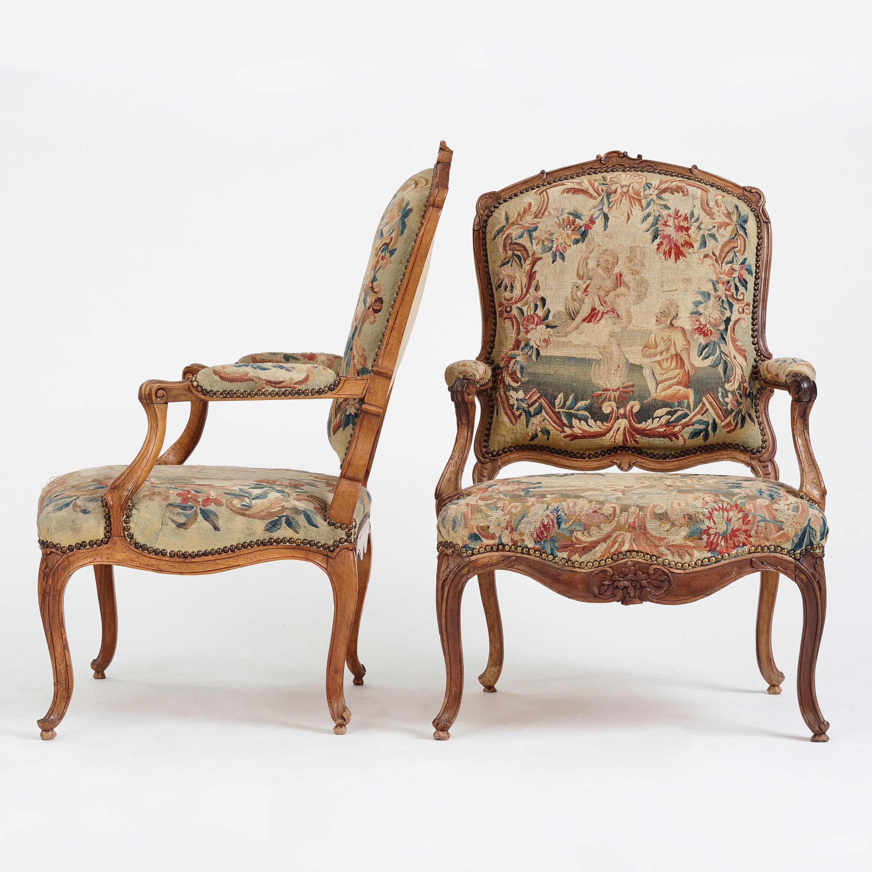 A pair of French very decorative 18th century Louis XV armchairs with Aubusson tapestry. Made in stained red beechwood. These chairs are quite large in size. 
 