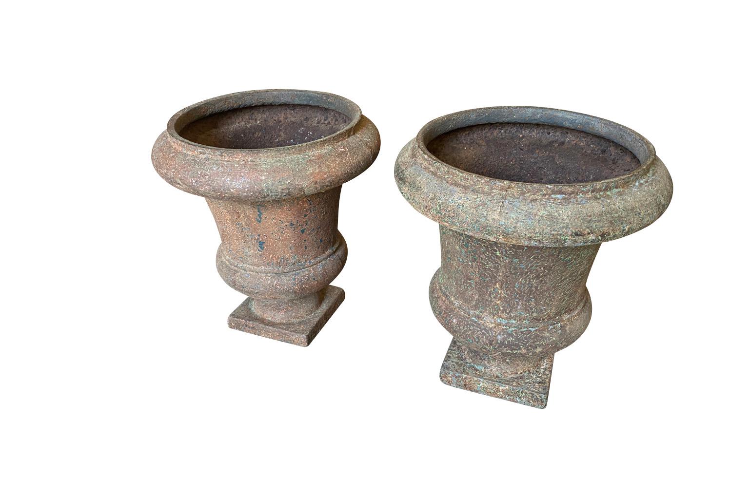 An exceptional pair of mid-18th century Medici Urns from the Provence region of France. Beautifully crafted from iron with stunning minimalist lines. Very weighty and excellent quality. Stunning patina.