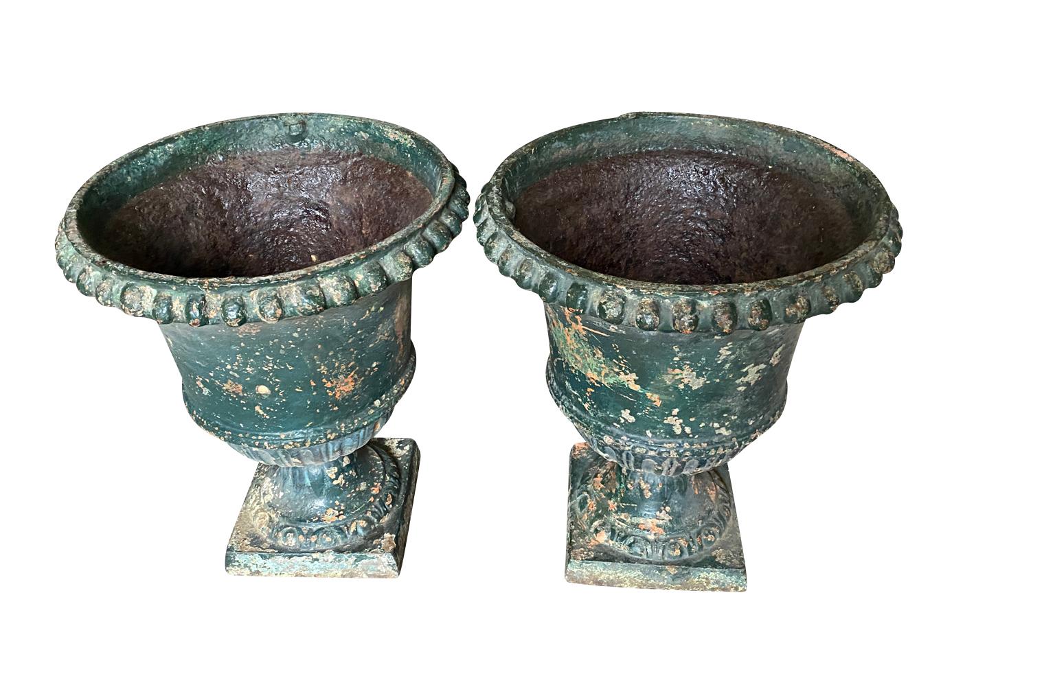 An exceptional pair of mid-18th century Medici Urns from the Provence region of France.  Beautifully crafted from iron with stunning lines.  Very weighty and excellent quality.  Stunning patina.