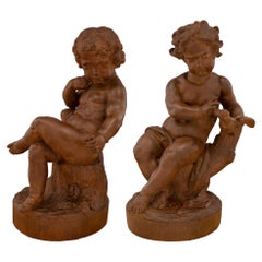 Pair of French 18th Century Terracotta Statues of Children Playing with a Bird