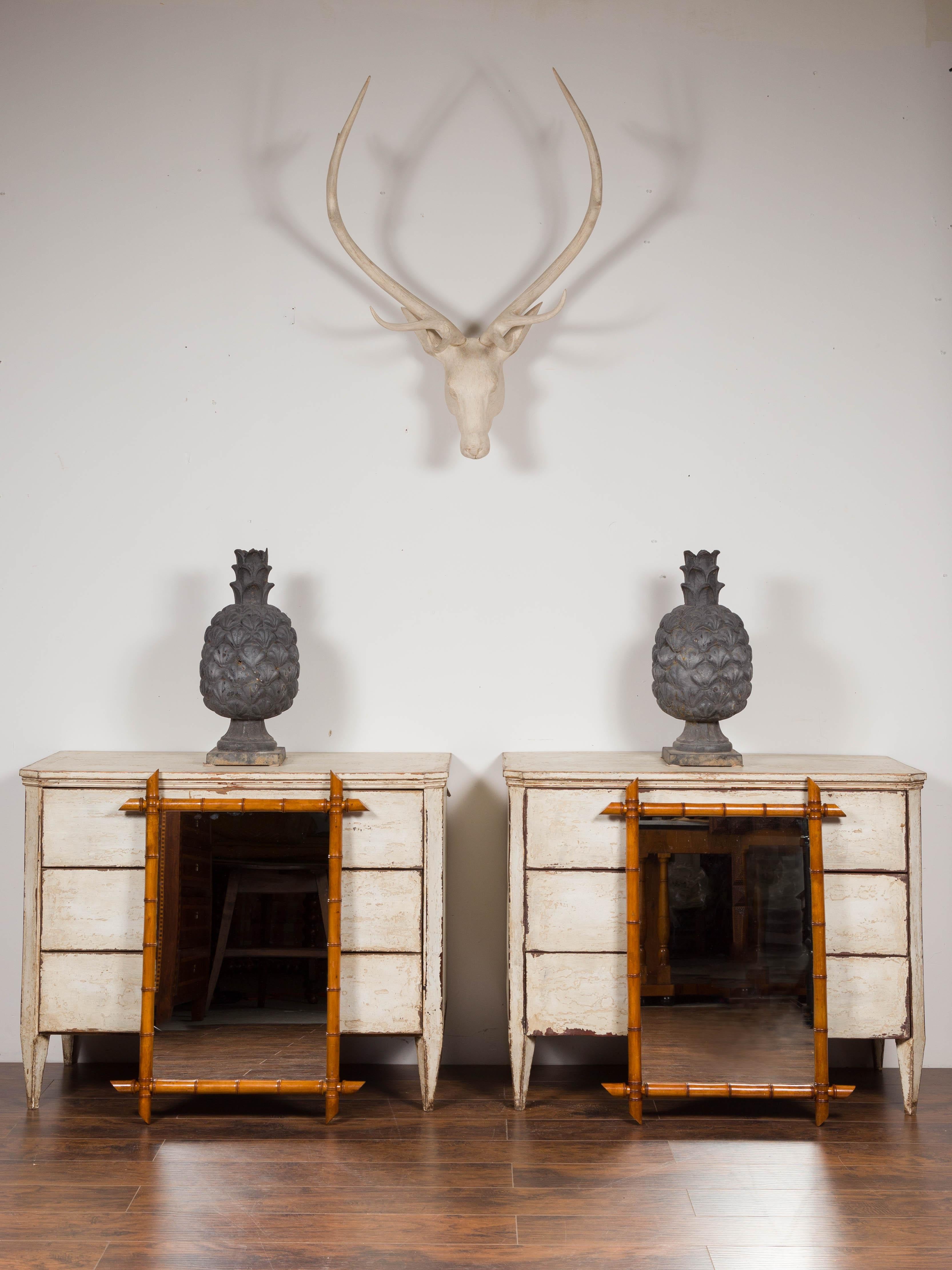 A pair of French rustic faux-bamboo rectangular mirrors from the early 20th century, with honey brown patina. Born in France during the early years of the 20th century, each of this pair of mirrors features a rectangular Silhouette made of a thin