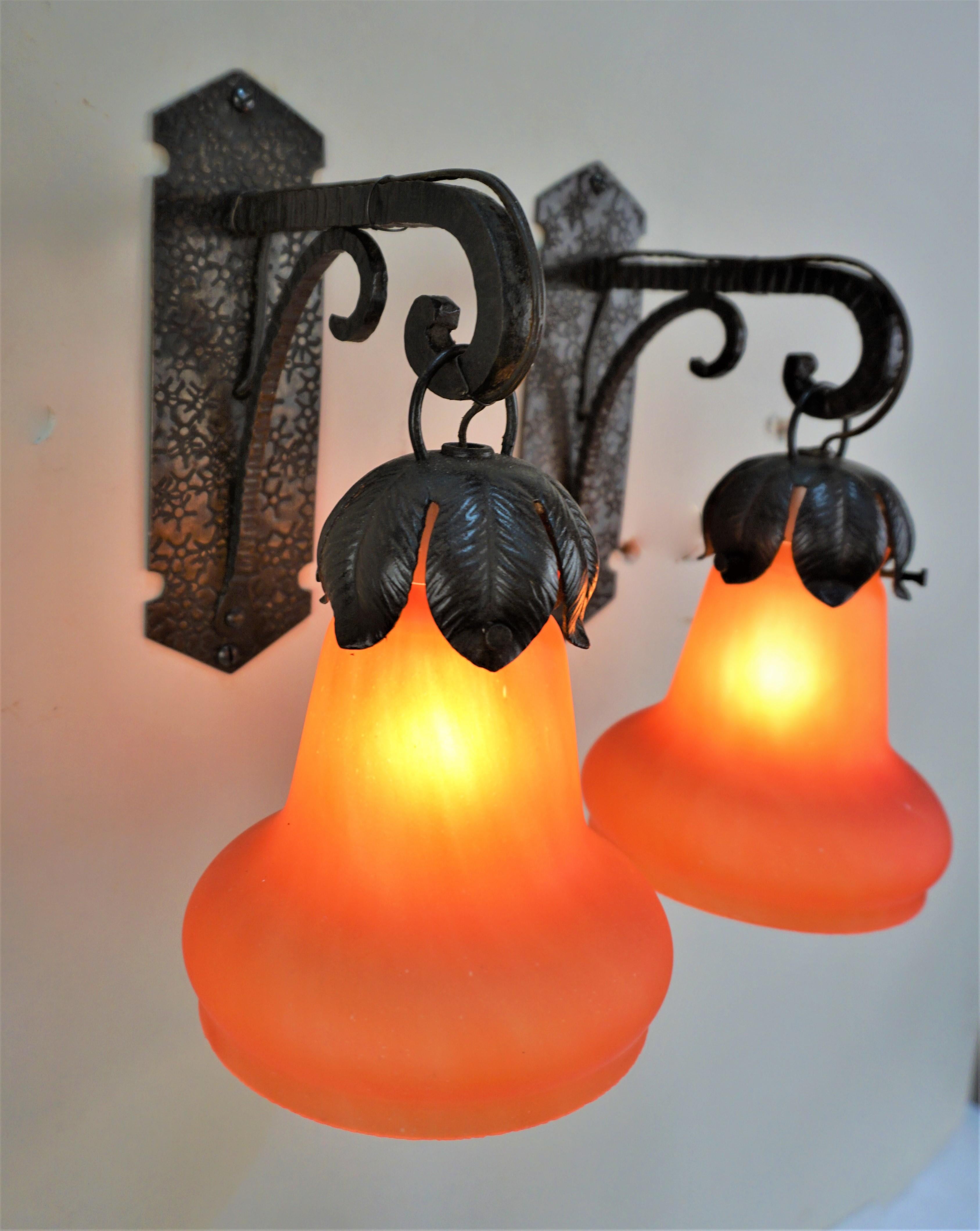 Beautiful orange/red blown glass shade with handmade iron work frame 1920's wall sconces.
Backplate 8