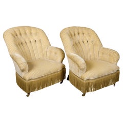 Pareja de Fauteuils Crapaud franceses de los años 20 con tapicería crema, sobre ruedas