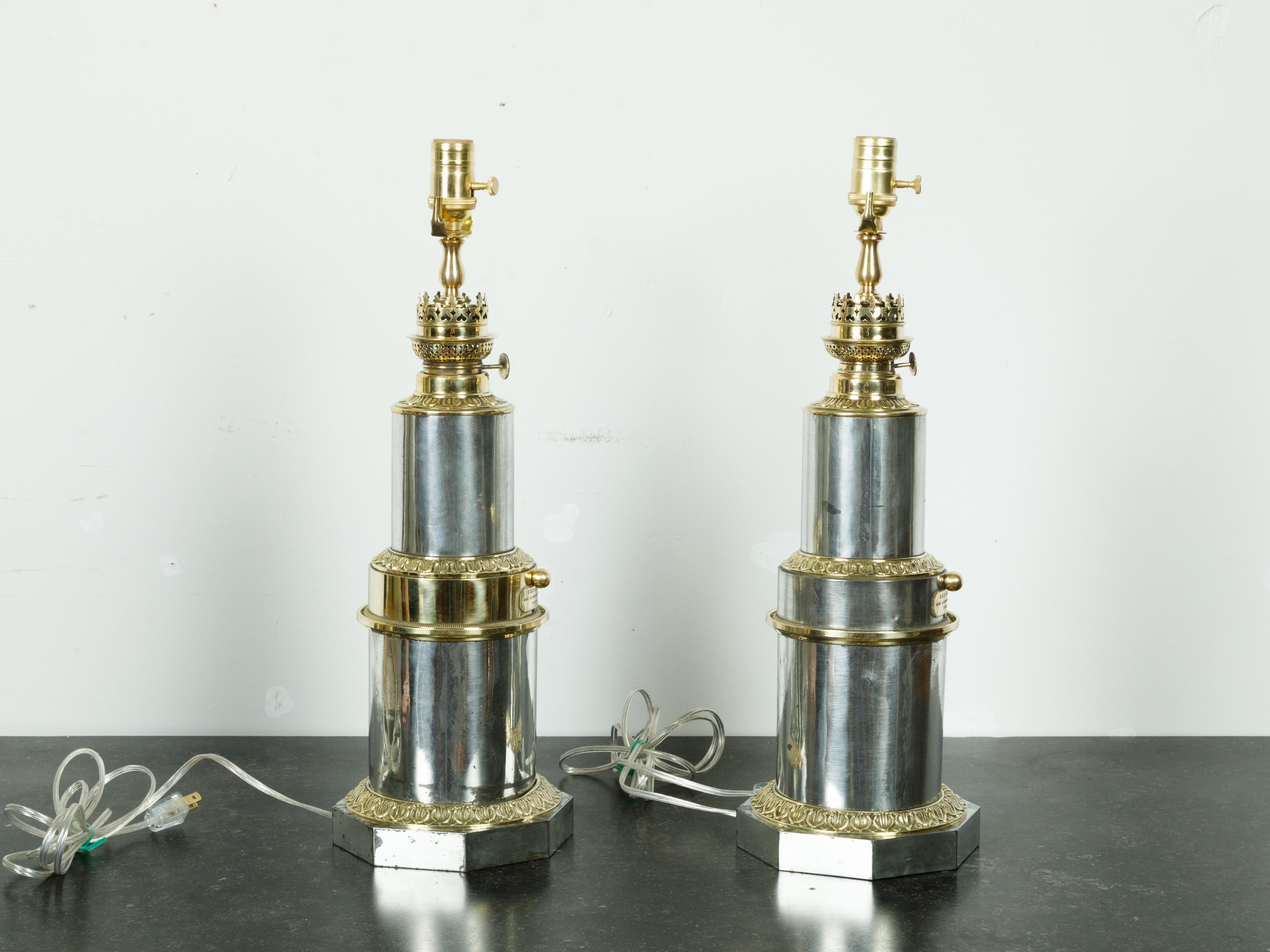 A pair of French Gagneau Paris steel and brass table lamps from the early 20th century with waterleaf motifs. Created in France during the first quarter of the 20th century, each of this pair of table lamps features a steel structure adorned with