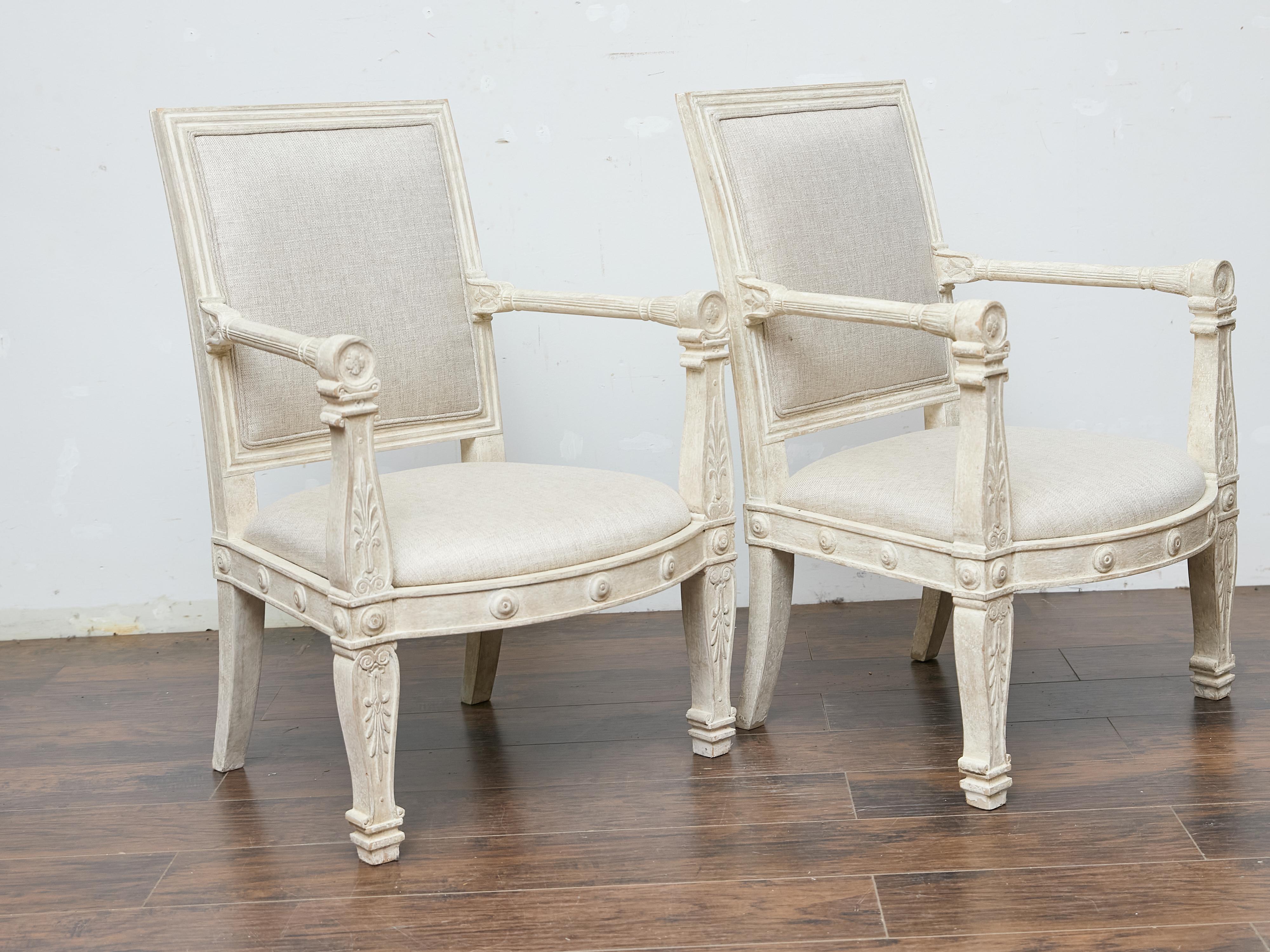 Louis XVI Pair of French 1920s Painted Armchairs with Carved Details and Linen Upholstery For Sale