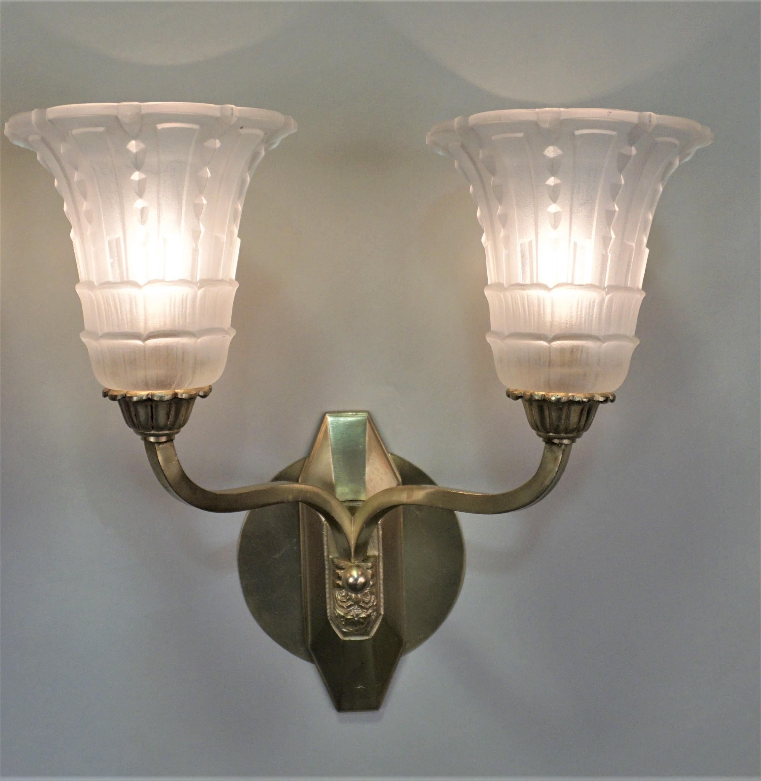 Double arm bronze Art Deco wall sconce with clear frost glass shades.