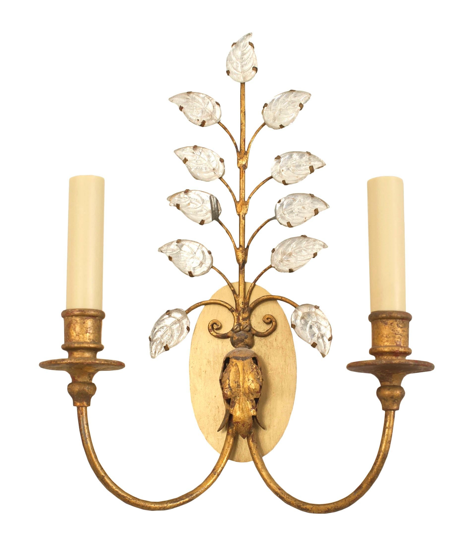 Pair of French 1940s gilt metal two-arm wall sconces with silvered crystal tiered leaf design by Baguès.

Baguès was born in Auvergne around 1840 and became famous internationally as a creator of art lighting. In the beginning it specialized in