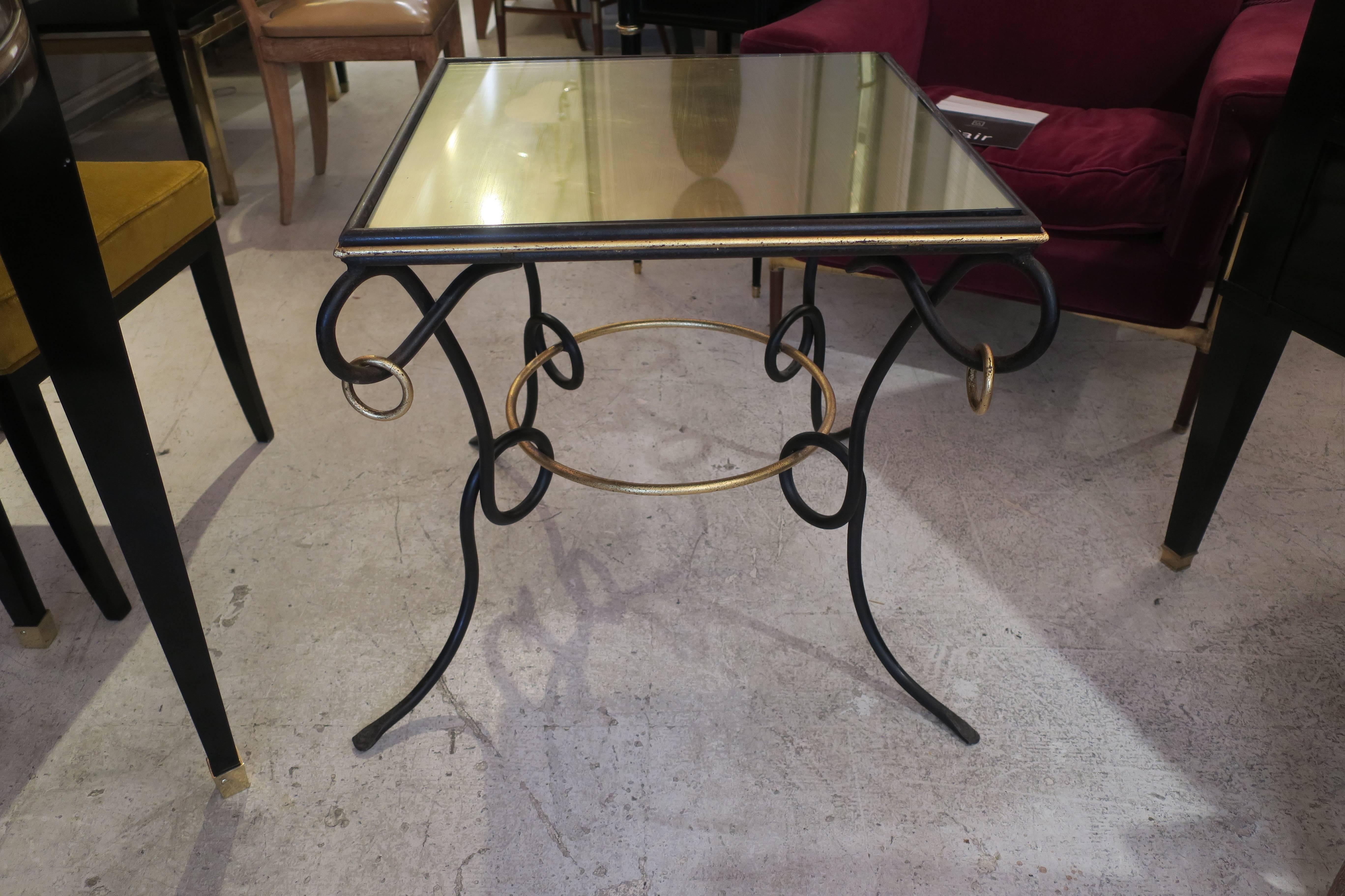Pair of French 1940s painted and gilt iron tables with ring decoration and gilt glass-top in the Rene Prou manner.