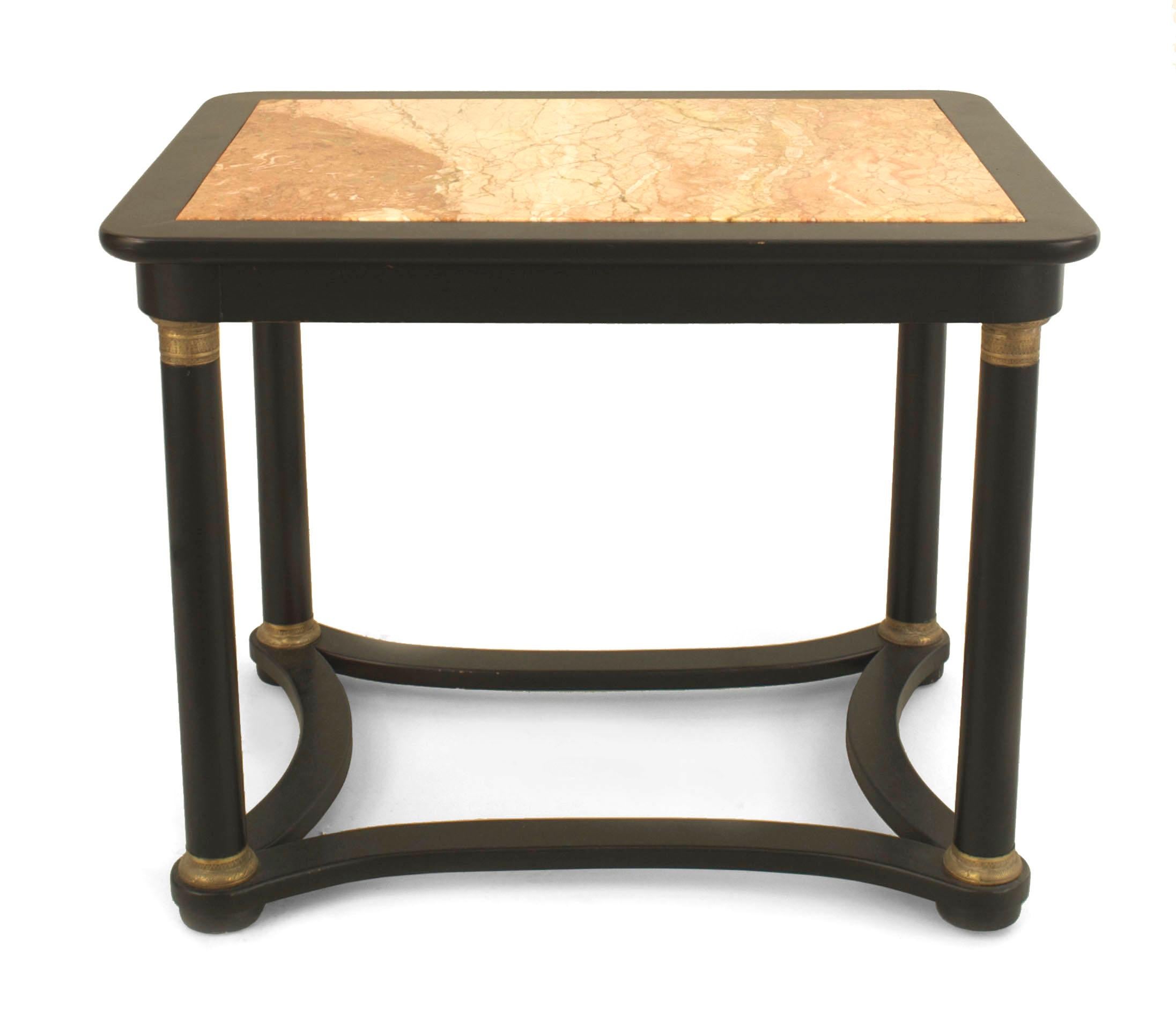 Pair of French 1940s (Regency style) ebonized and gilt trimmed rectangular low end tables with four cylindrical legs connected by a shaped stretcher with an inset marble top attributed: Jansen.

Maison Jansen was a Paris-based interior
