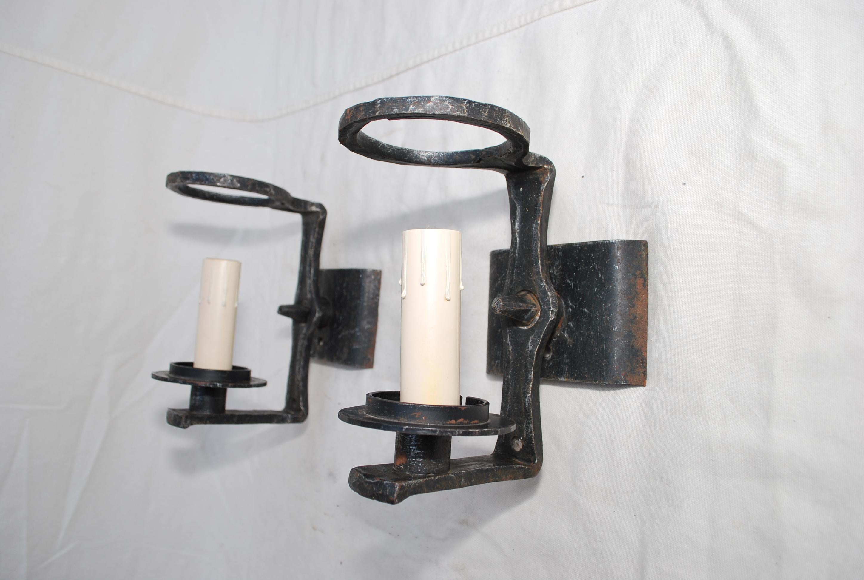 A nice and thick pair of french 1940s wrought iron sconces.