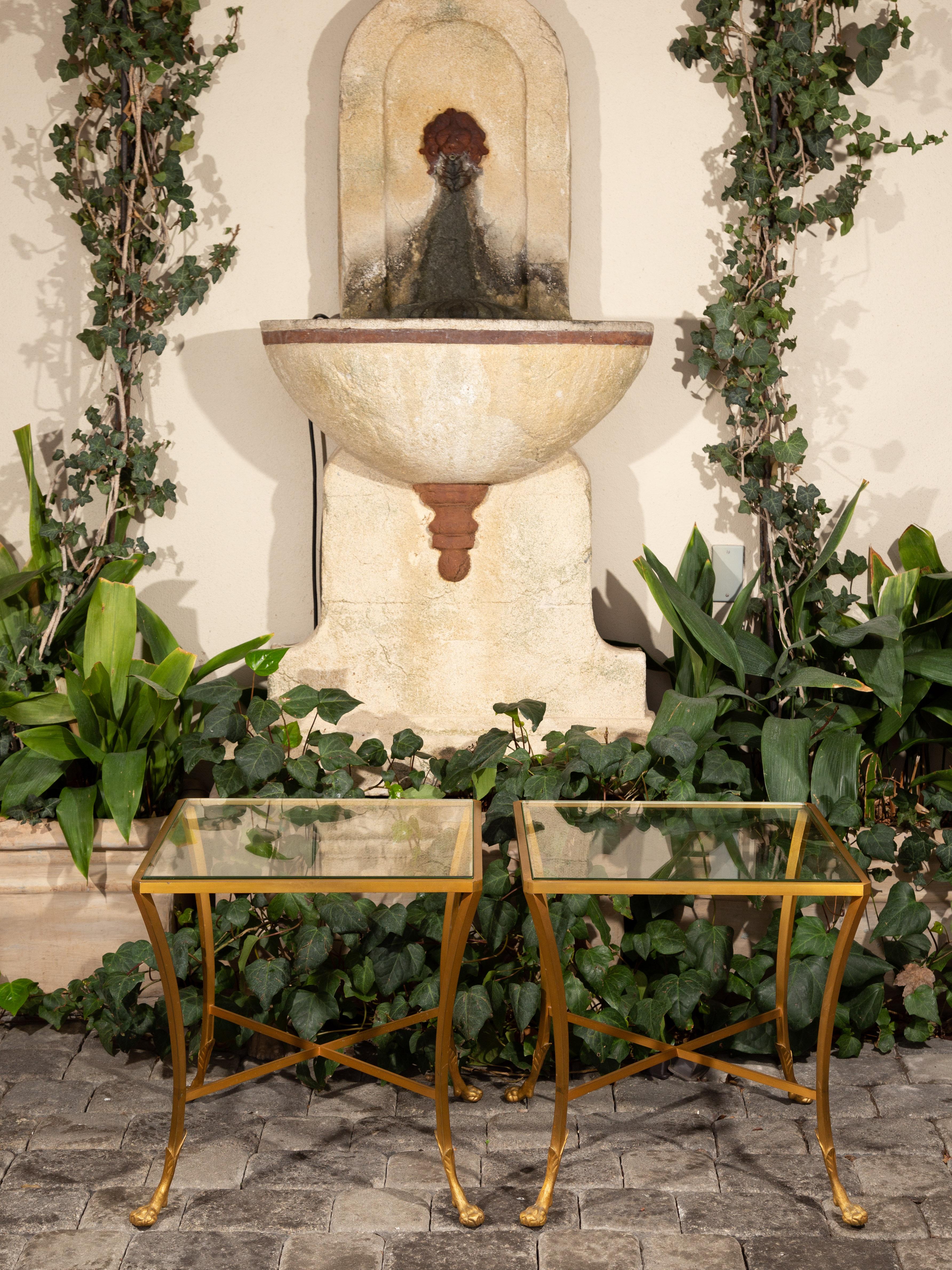 A pair of French vintage Maison Baguès gilt bronze style side tables from mid-20th century, with paw feet. Created in France during the mid-century period, this pair of French Maison Baguès style drink tables features exquisite gilt bronze frames