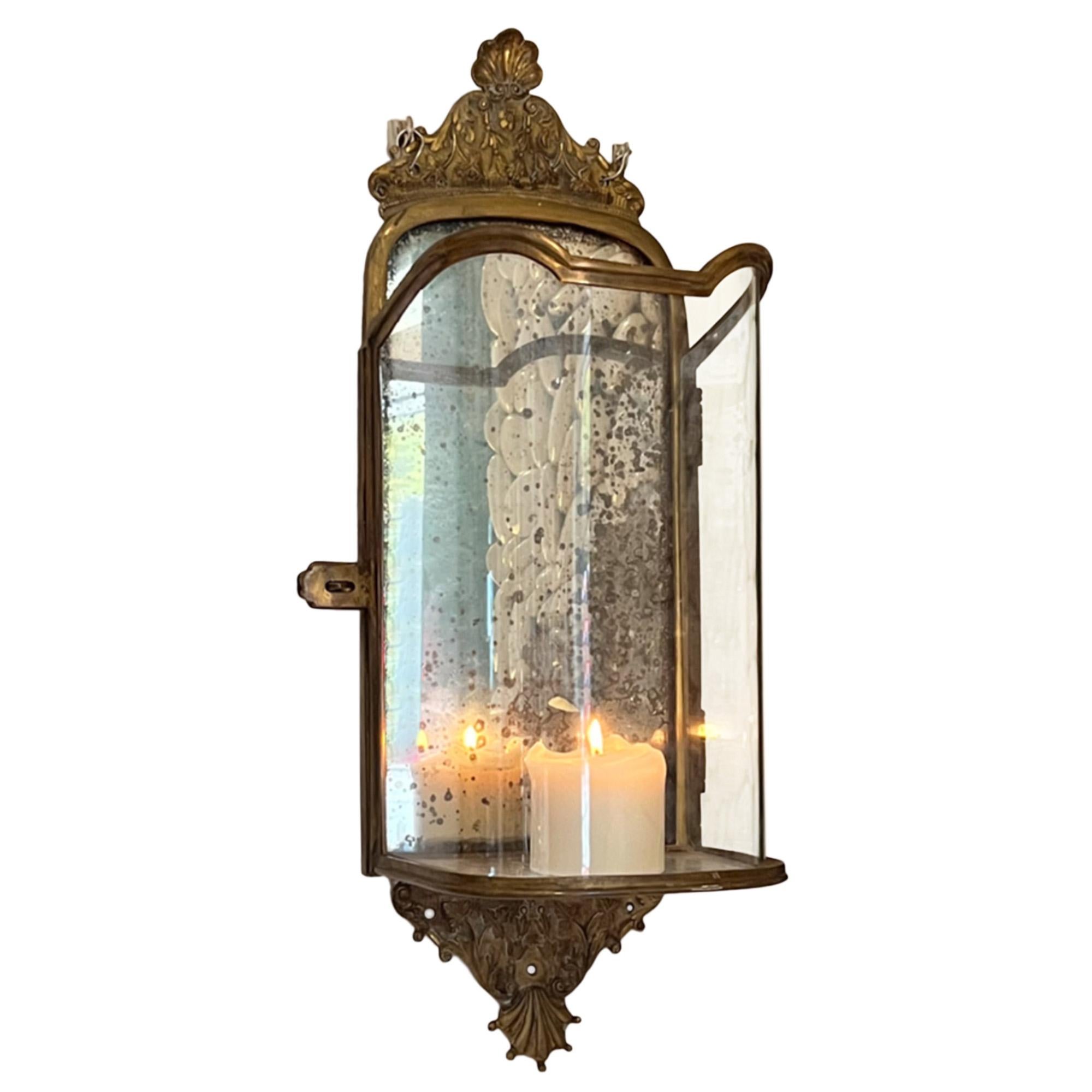 This stunning pair of wall lanterns were made in France in the 1950s. Made in an antique style with the original eglomise glass backs. A really elegant design with the curved glass fronts. 

As you can see, we've just added simple cream candles