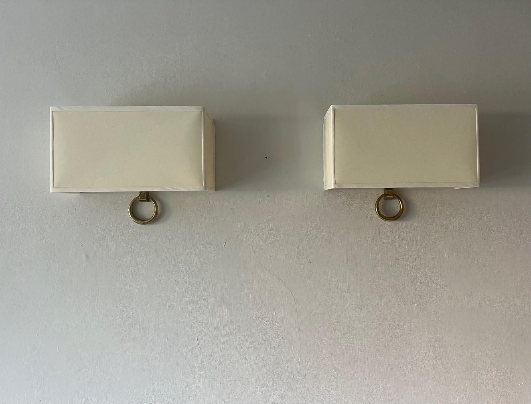 A pair of very elegant gilt metal wall lights/appliques by Marcel Guillemard. Numbered and stamped. Rewired and sold with replacement parchment card shades.