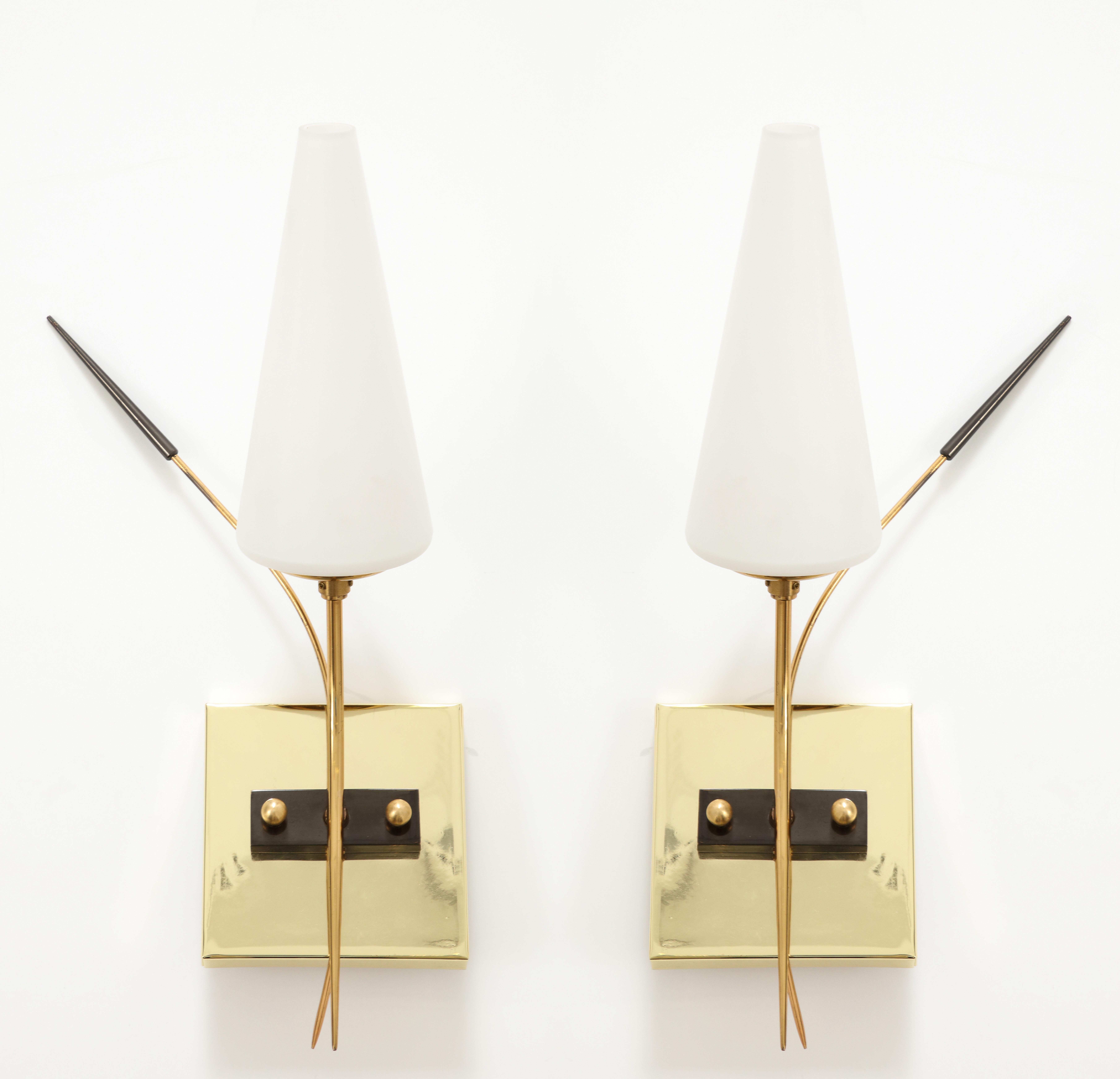 Pair of 1950's Brass and Opaline Glass sconces by Lunel.
The sconces have been newly rewired for the US with a candelabra socket that takes up to 40 Watts.