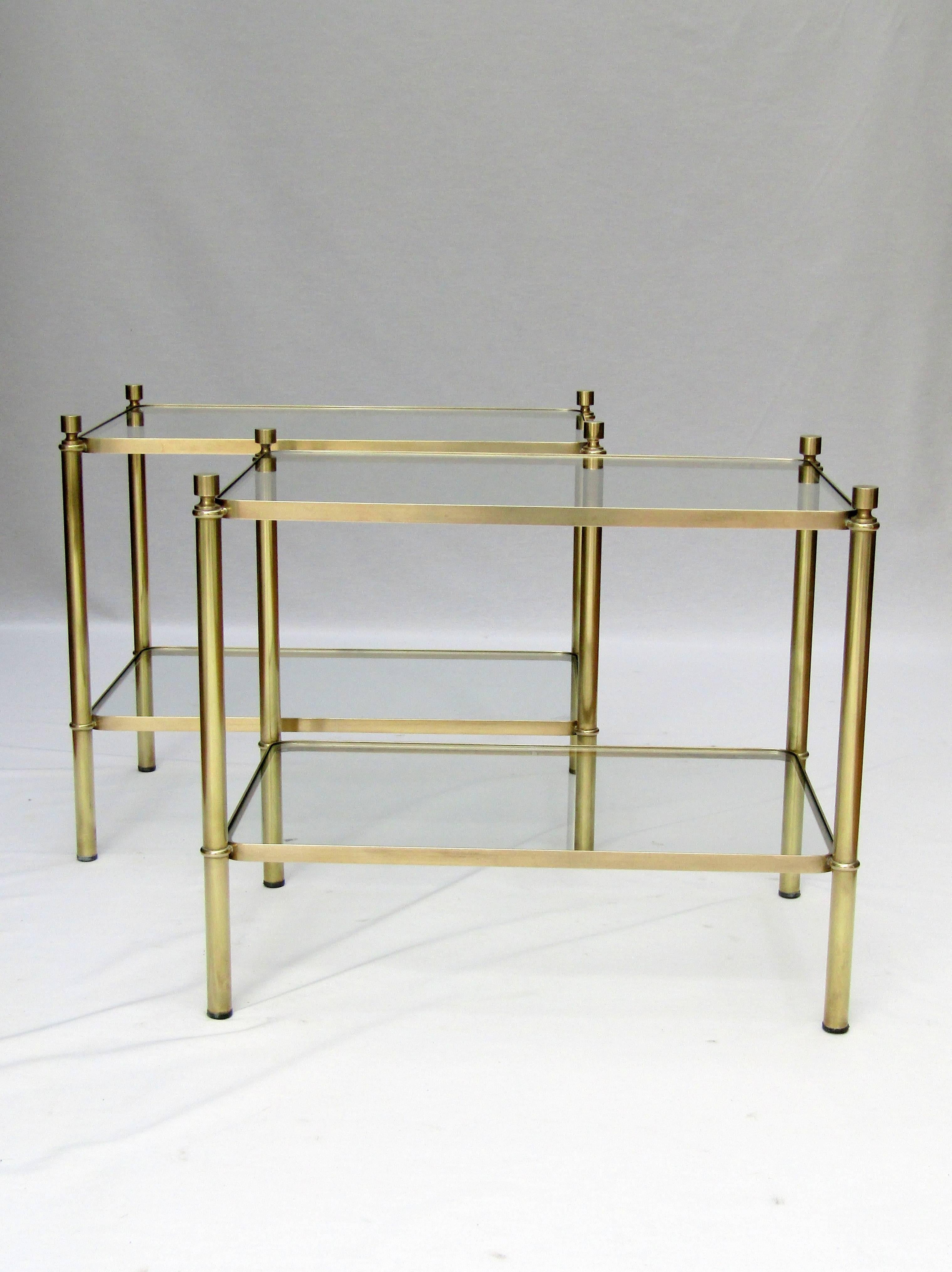 A pair of two-tier brass and glass end tables
French circa 1960

Height: 17 ½ in / 44.5 cm
Width:  20 ½ in / 52 cm
Depth:  14 in / 35.5 cm
