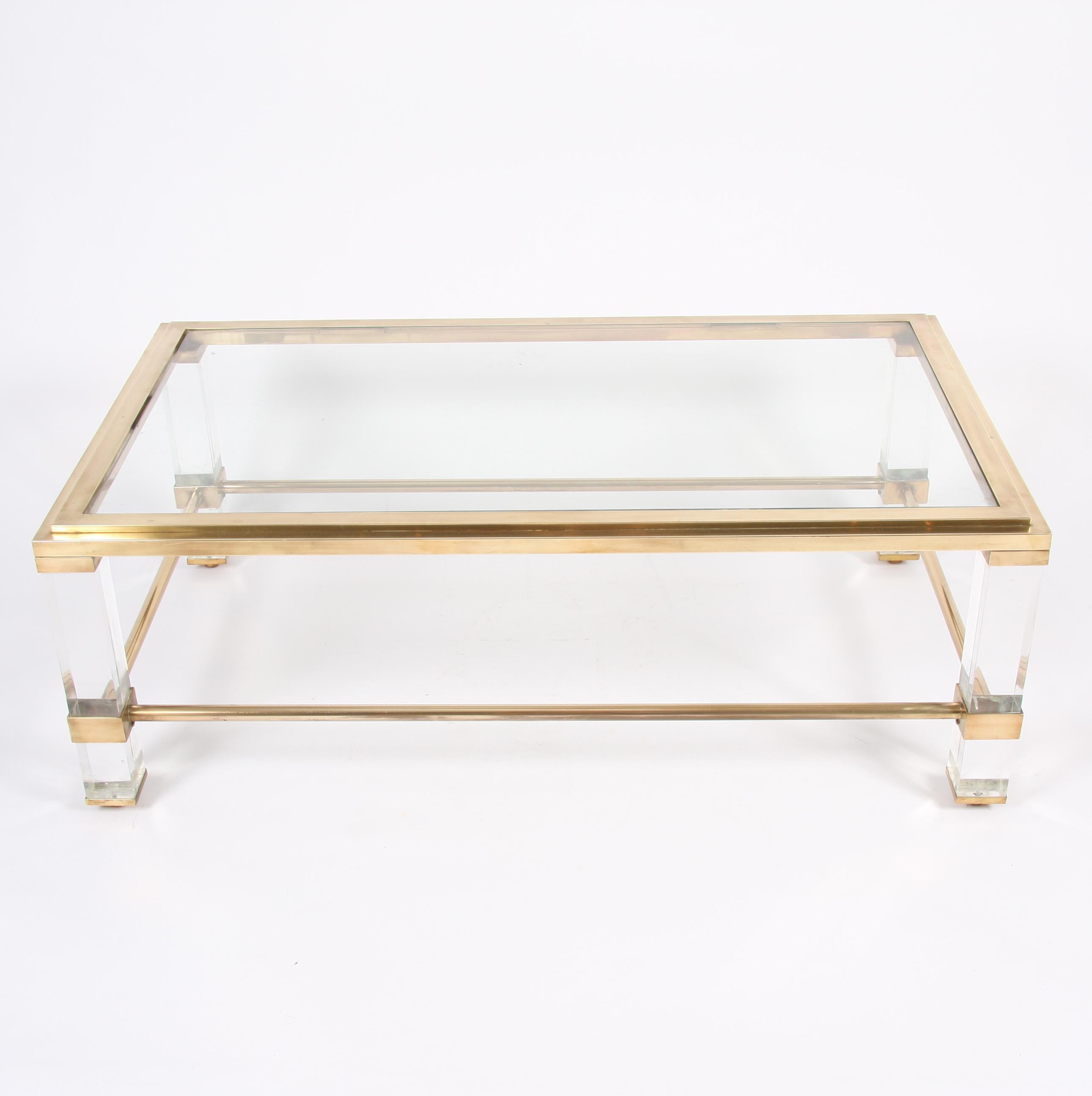 This pair of elegant brass and Lucite coffee tables date back to 1960s, France.