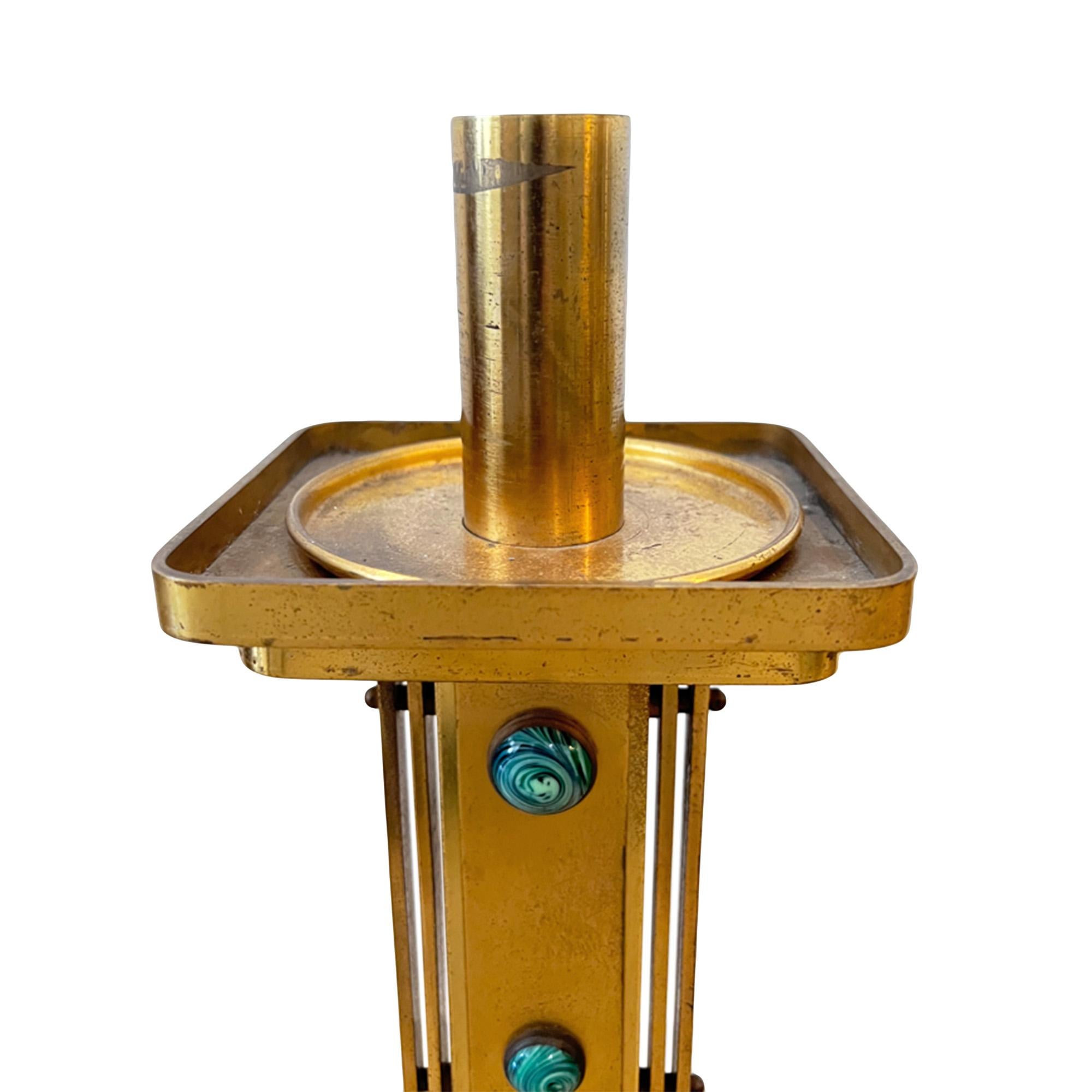 A great pair of guilded brass candlesticks decorated with attractive green malachite stones. The stones are larger at the top and decrease down in size as the design moves down the columns. 

Very decorative and practical - a lovely addition to a