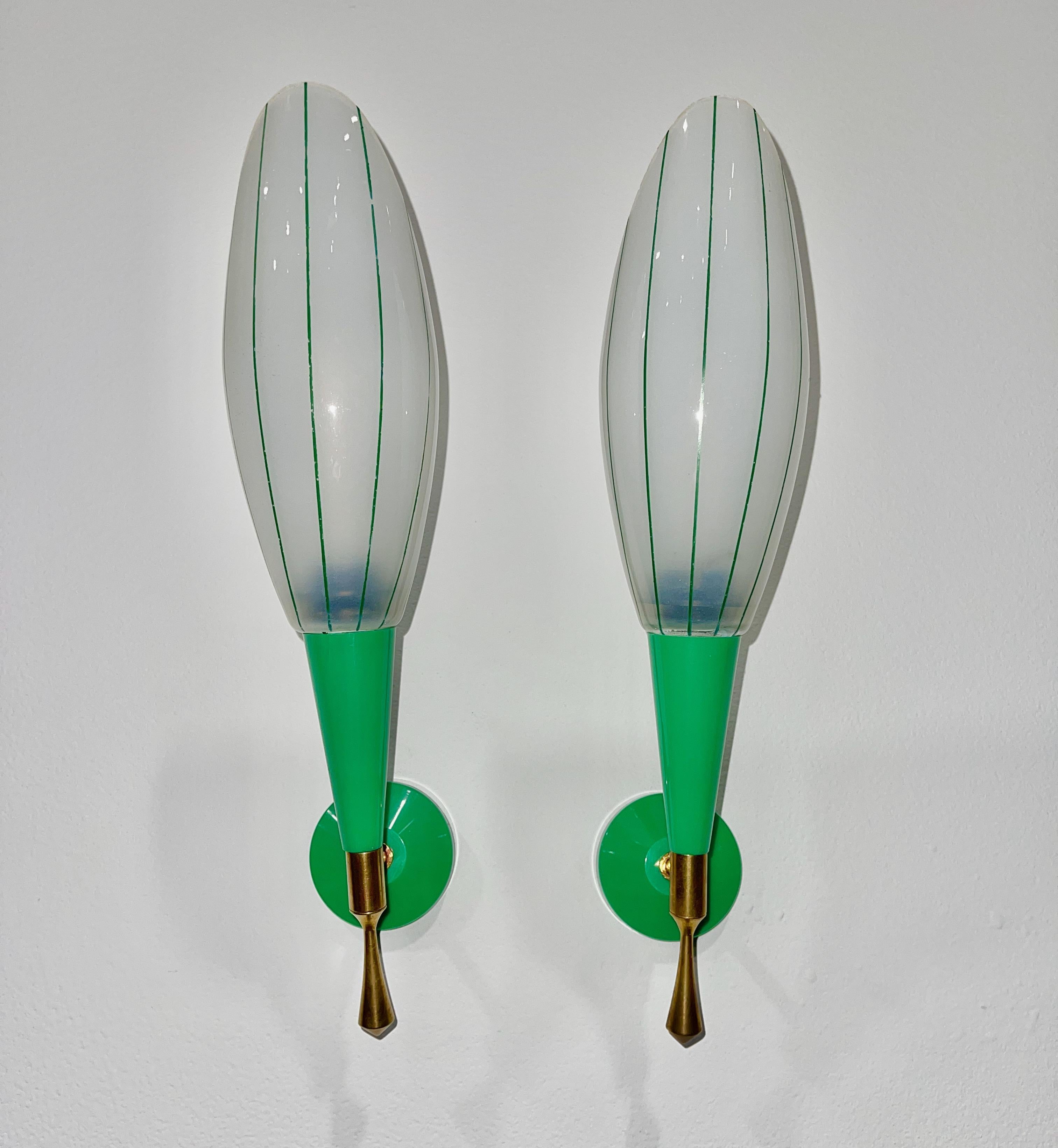 Pair of colorful French sconces from the 1960's in vibrant green plastic with brass fittings and ovoid opaline glass shades which are pin-striped in green enamel.  Each takes one 40 watt candelabra bulb.  They are 14.5