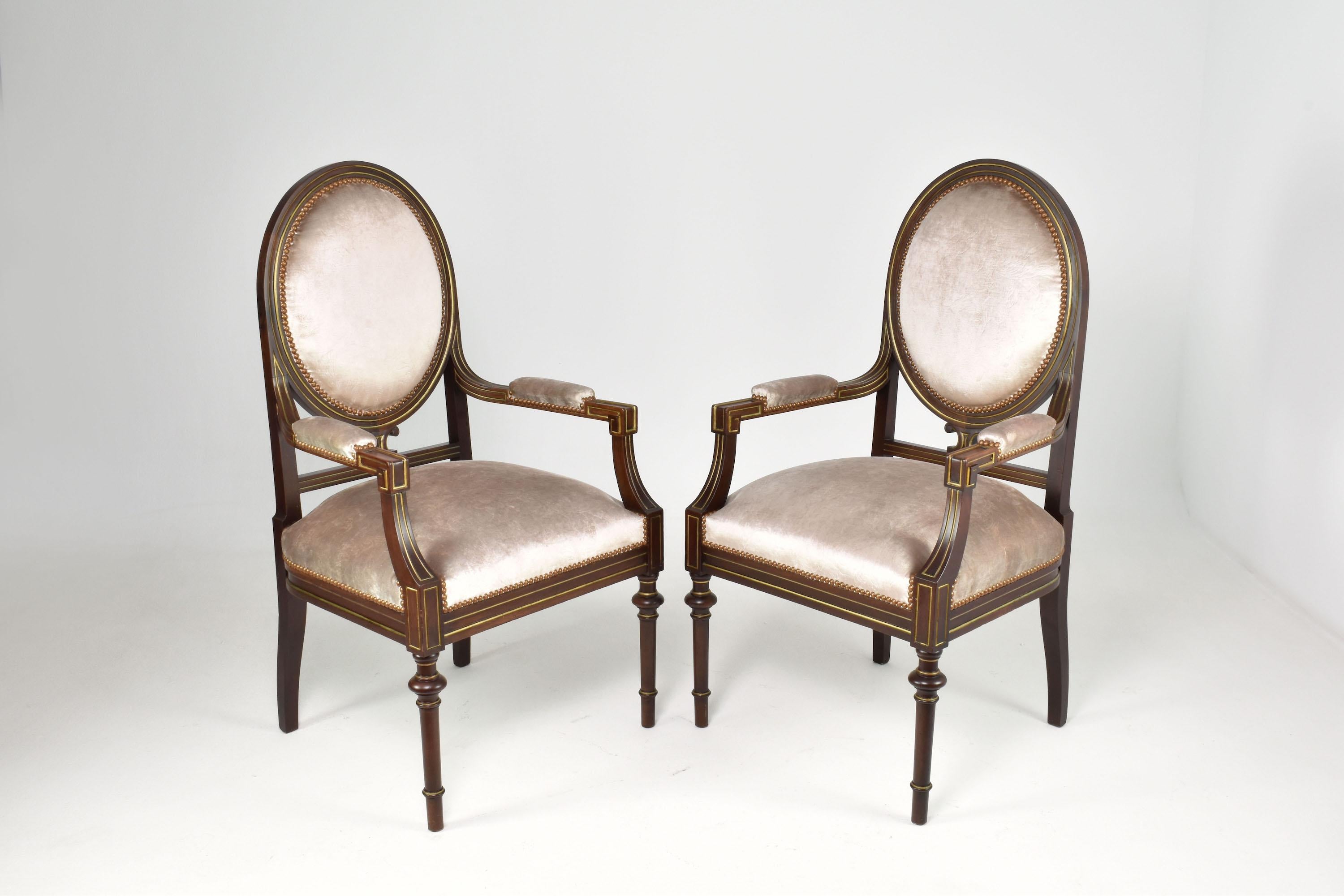 Introducing a pair of French Louis XVI-style chairs from the 1960s, restored by our atelier. These neoclassical armchairs showcase a flawless fusion of traditional elegance and contemporary refinement. They are crafted with a solid wood structure,