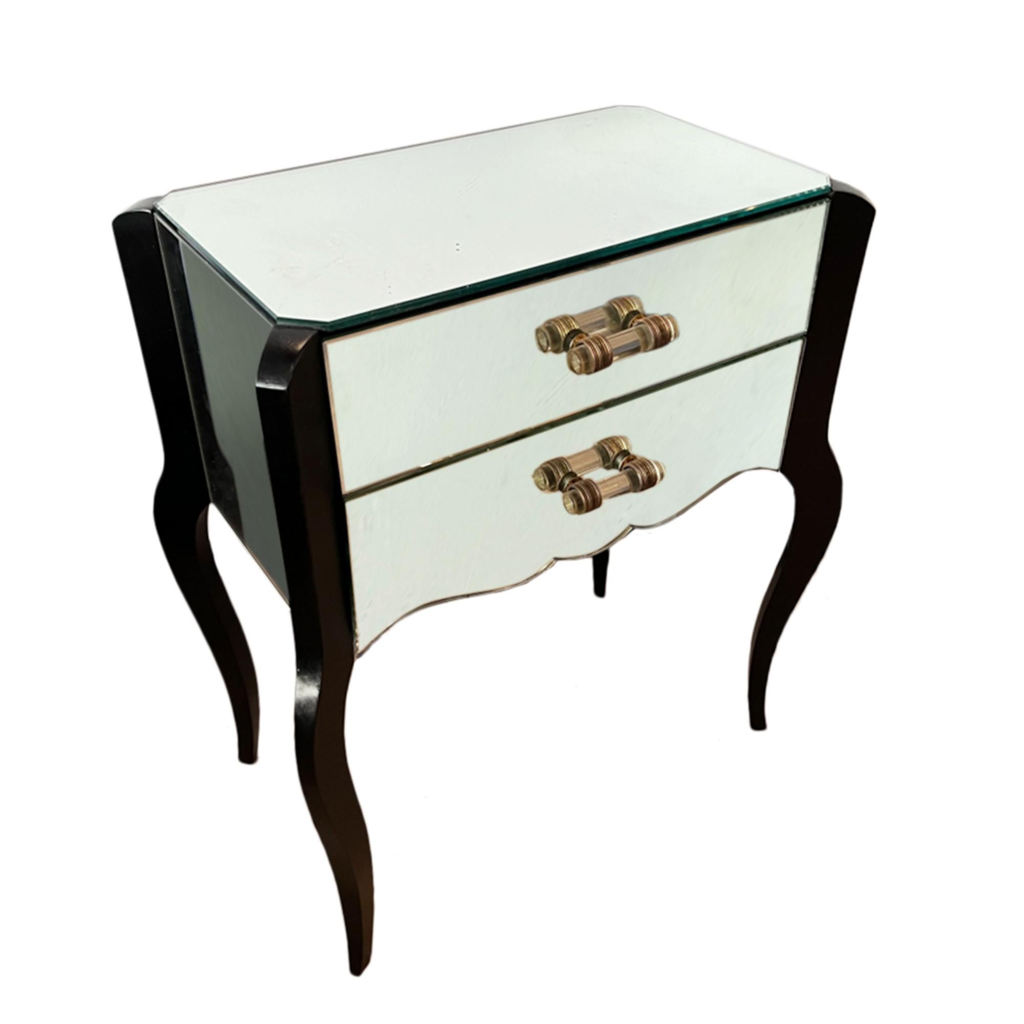 A gorgeous pair of mirrored bedside tables, made in France in the 1960s. 

With 2 drawers, elegant cabriole legs and nice detail on the handles. 

A good pair of mid century nightstands.