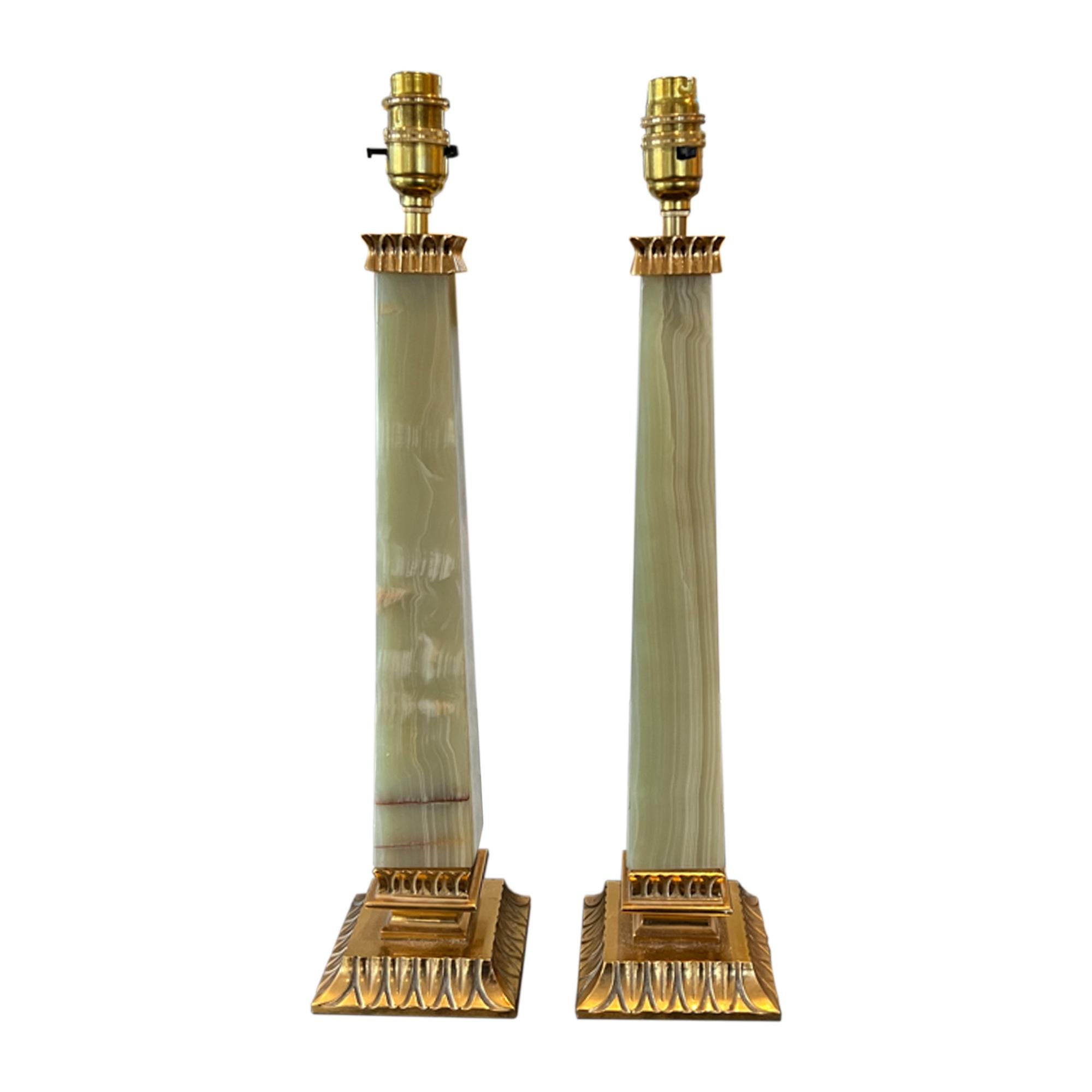 A very attractive pair of onyx table lamps - please take a look at all our pictures to see the natural pigmentation in each piece of stone. An elegant shape with tapering columns. 

The lovely pale green colour is enhanced with the brass trim -