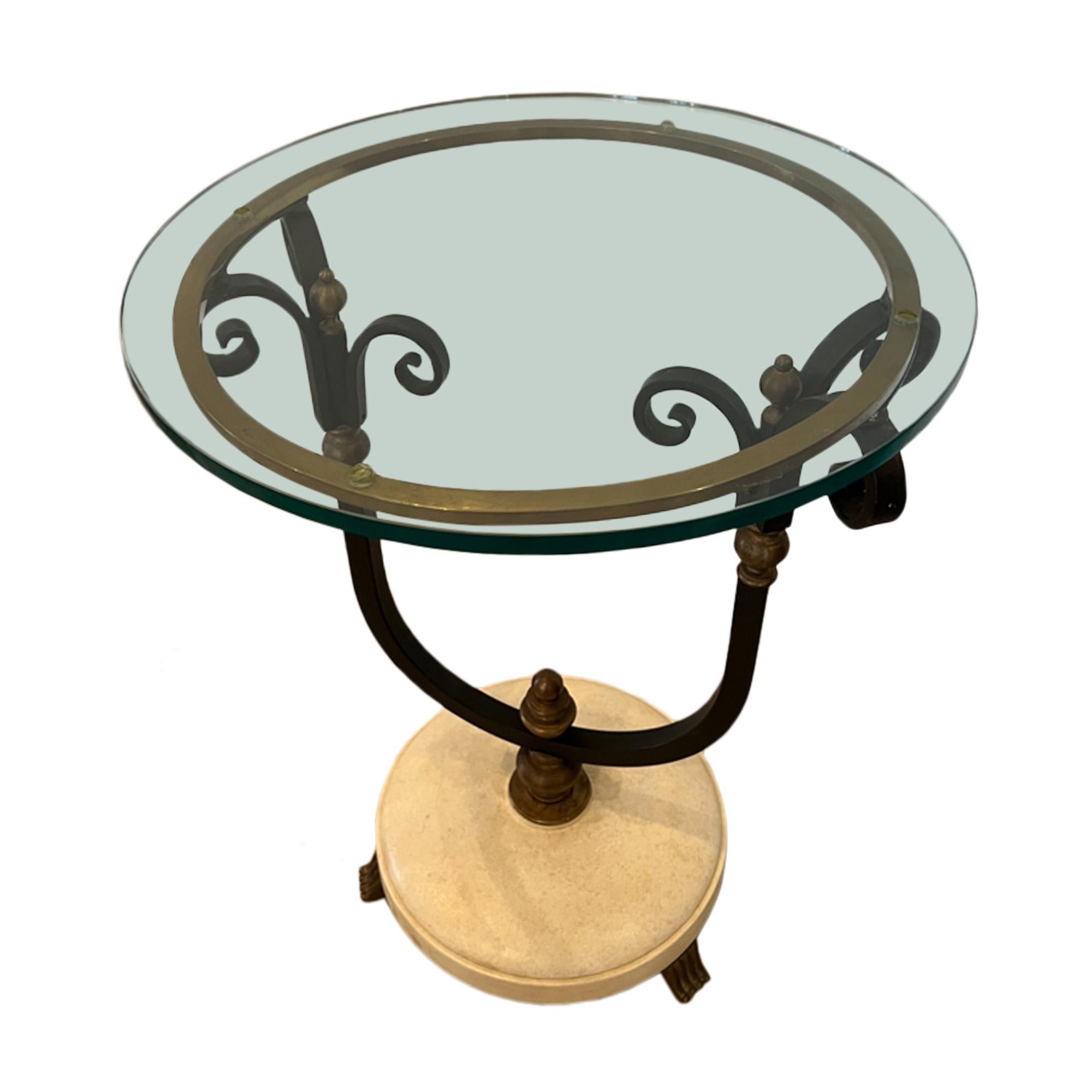 A stylish pair of glass topped side tables, crafted from wrought iron and brass. The base is painted faux parchment with 3 brass feet on each piece. 

Made in France in the 1960s.

The base diameter is 32cm.