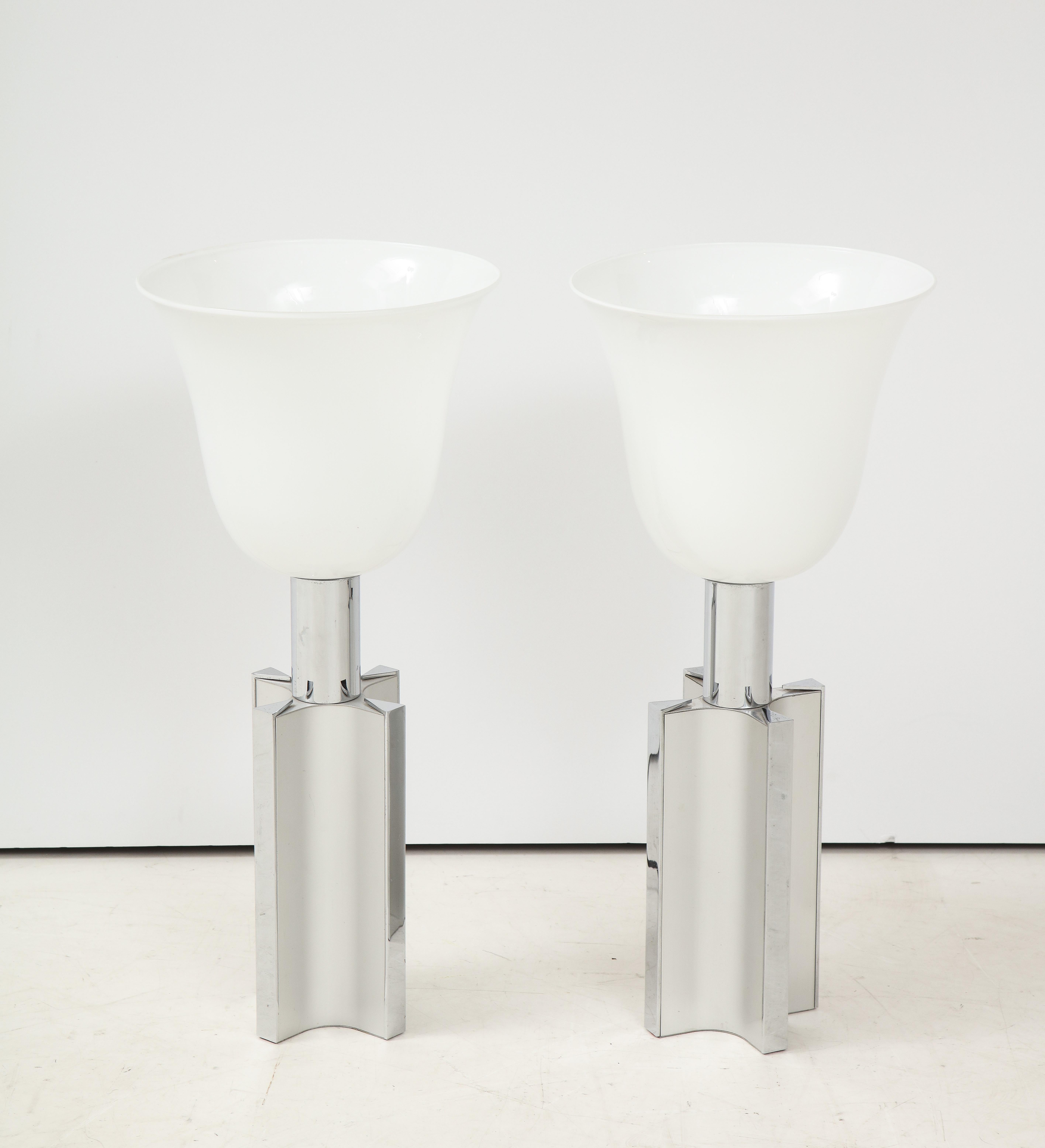 Pair of French 1970s chrome and aluminum table lamps.
The Art Deco influenced lamps have their original glass shades and are newly rewired with black rayon cords.