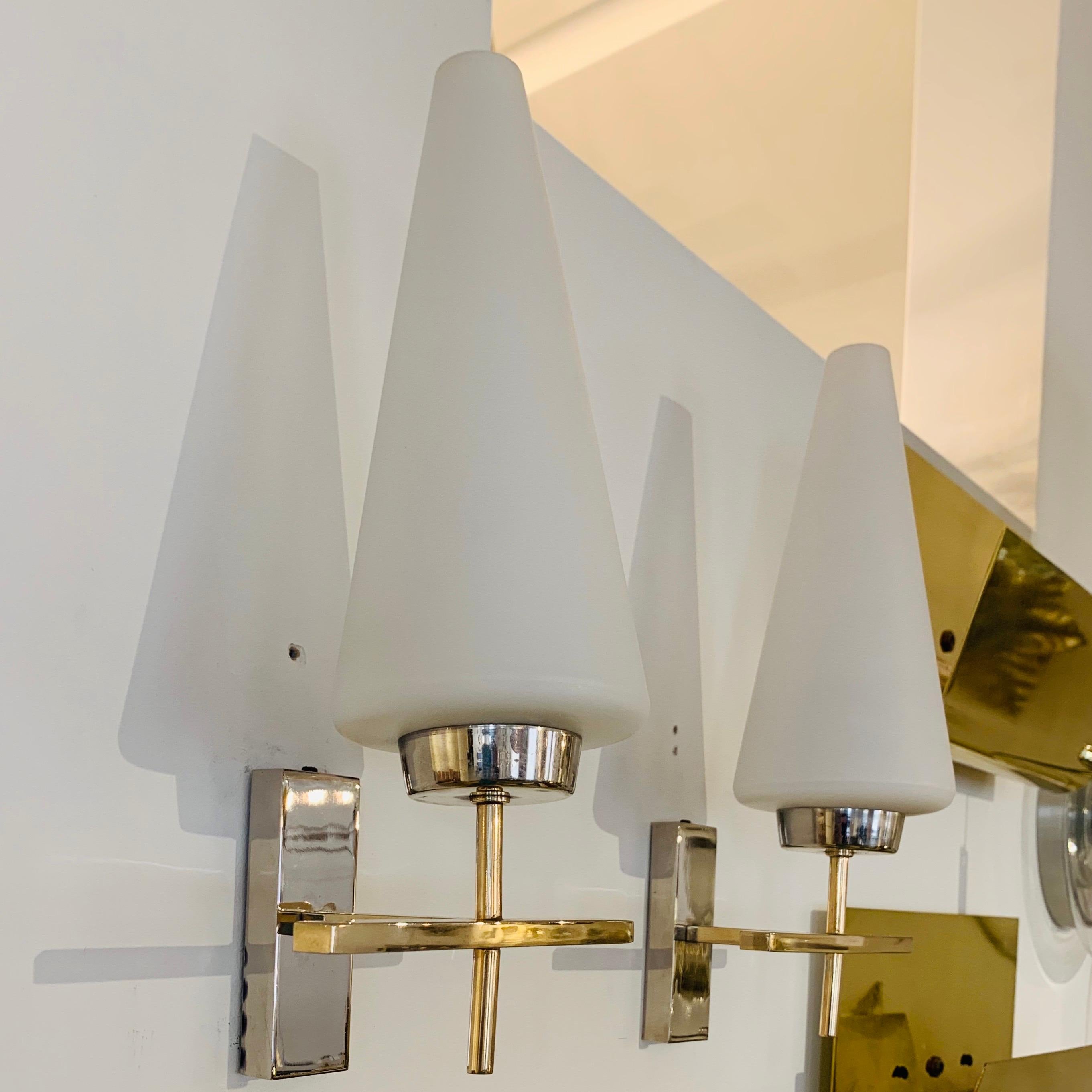 An excellent pair of 1970s French brass and polished chrome sconces with white opaline glass cone shades. Rewired. listing is for a pair, a set of two.