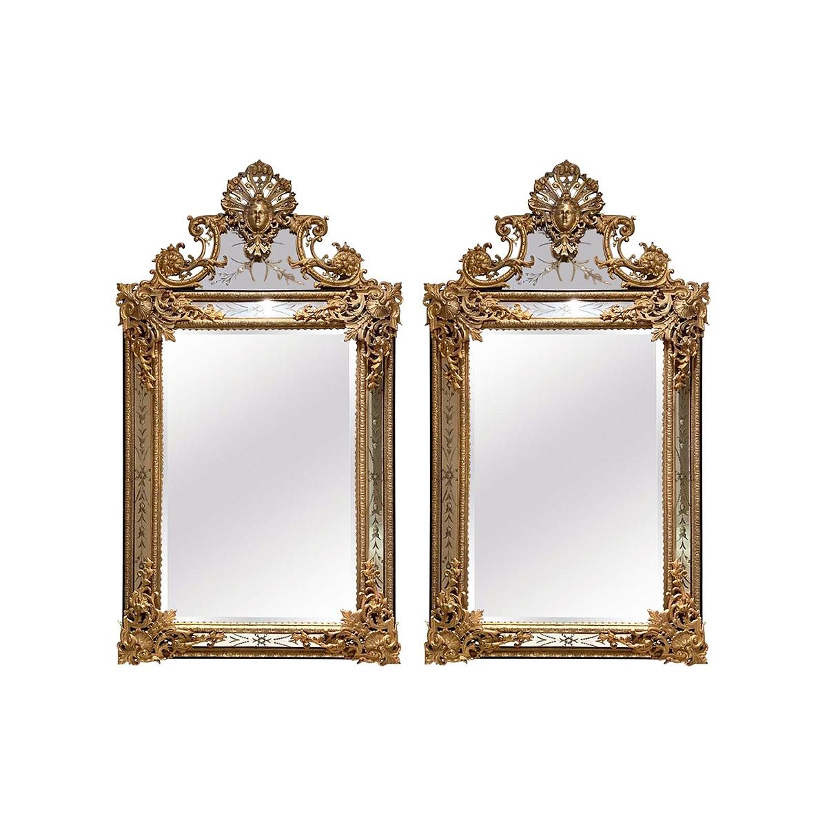 A fine pair of French 19th-20th century Louis XIV style gilt-bronze (Ormolu) mirror frames. The ornately decorated Rococo frames, each crowned with an allegorical mask of maiden flanked by a floral design with scrolls, acanthus and seashells, the