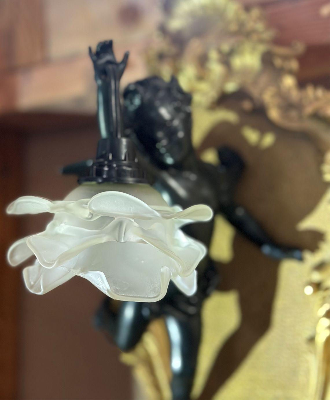 Pair of lovely wall sconces made in France in the Late 19th Century in the manner of Francois Linke, consisting of a gilt bronze frame and black patina cherub figures. The cherubs are gracefully holding a dainty flower-shape light.
*Rewired to fit