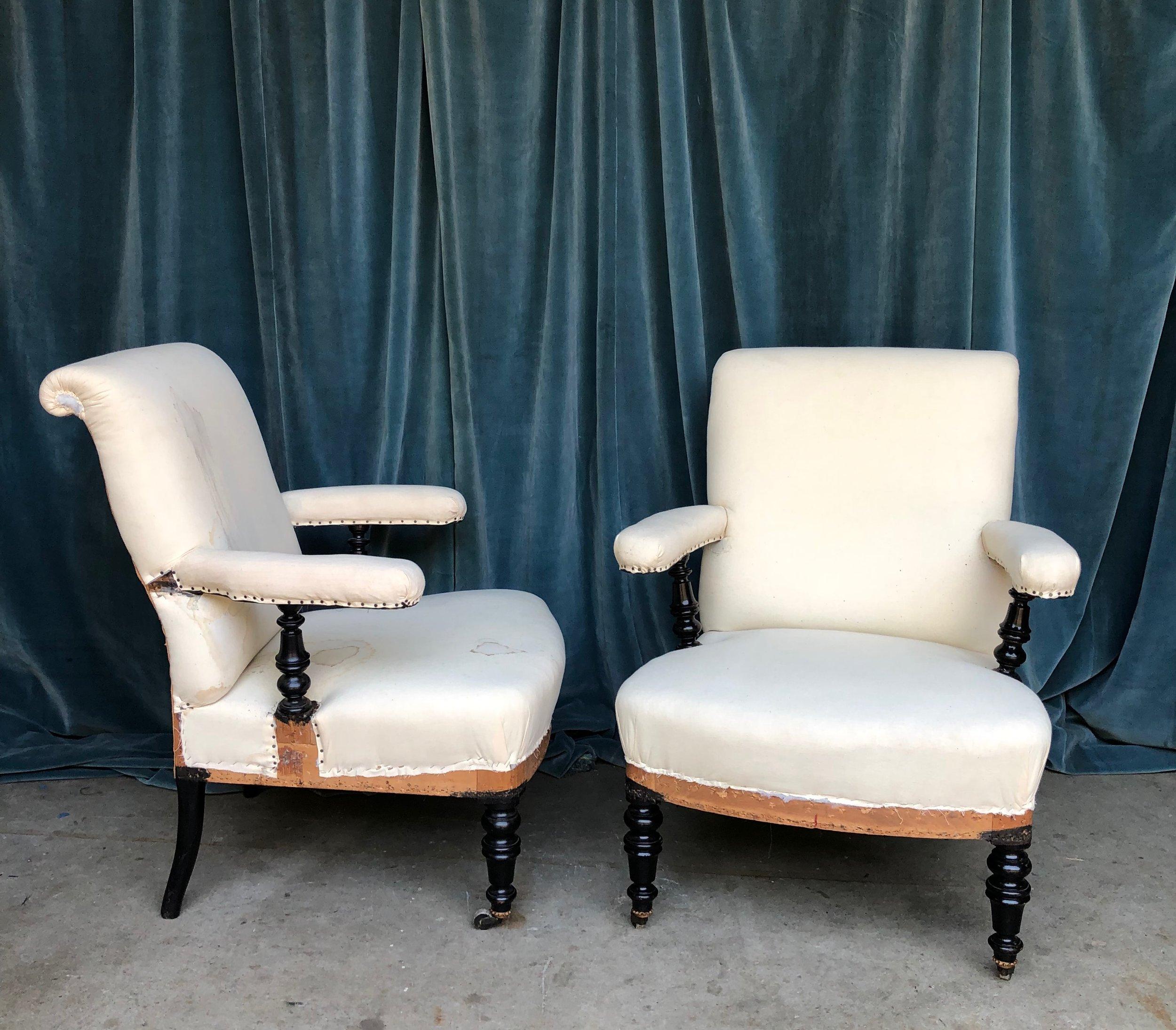 This handsome pair of 19th century French Napoleon III armchairs are unique and one of a kind. The chairs feature 'floating' arms that rest on turned ebonized supports, mirroring the turned legs characteristic of this period. Adding to their