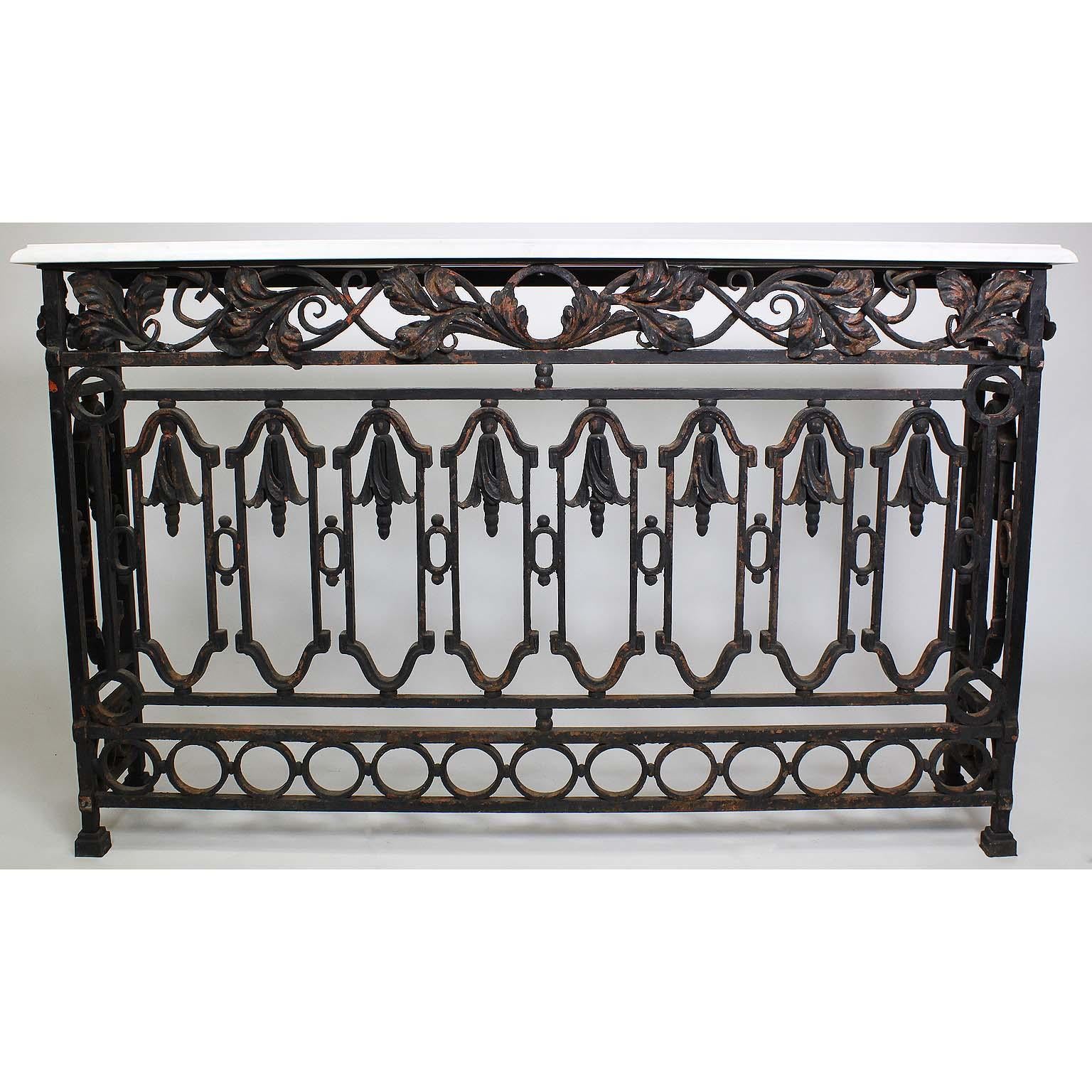 A pair of French, 19th century free-standing wrought iron wall console tables. The slender wrought iron bodies surmounted with leave and flower ornaments on an architectural frame with its original distressed and weathered black paint finish. The