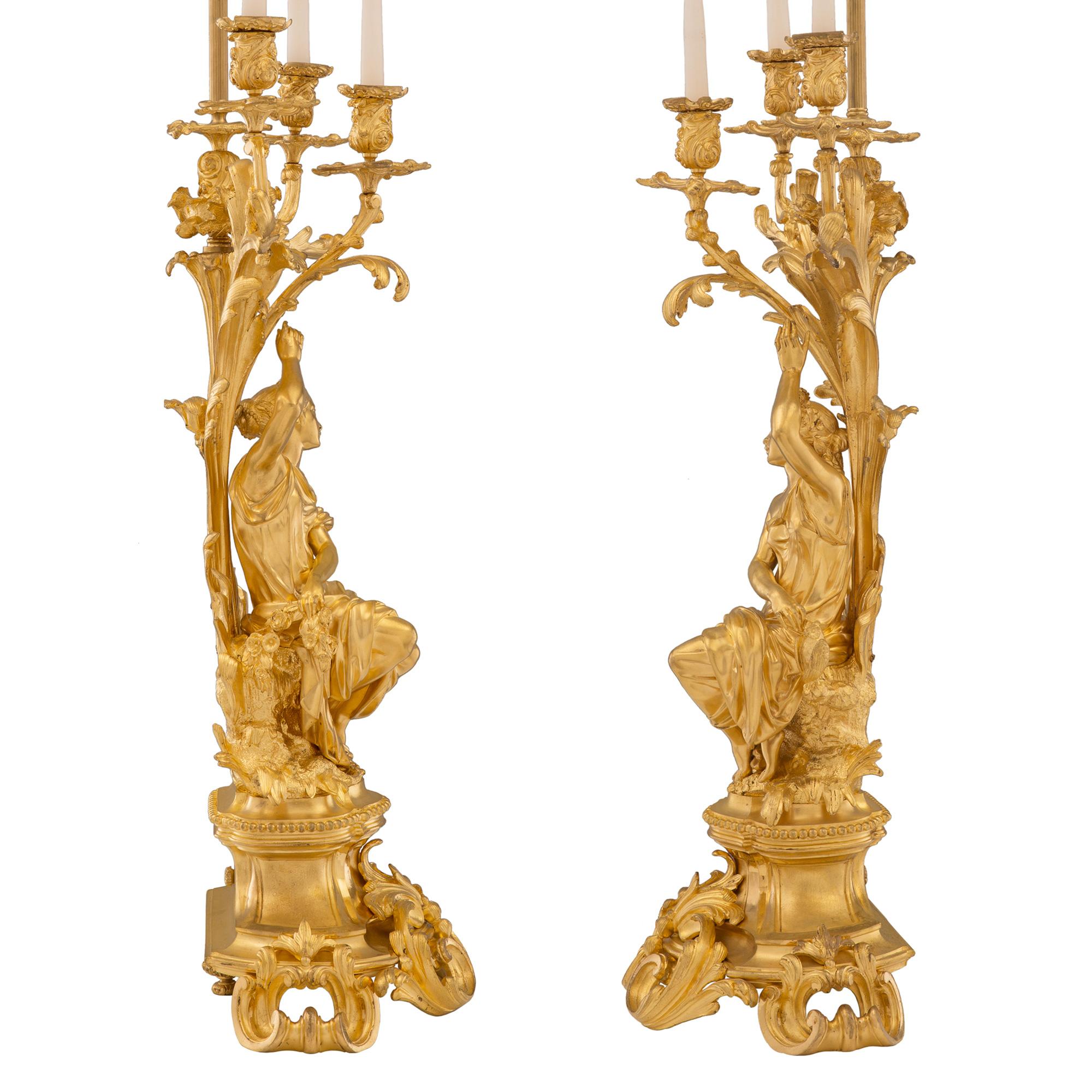 A sensational and extremely high quality French 19th century Louis XV st. Belle Époque period ormolu candelabras lamps, signed Picard. Each lamp is raised by a striking and most decorative socle shaped support with beautiful pierced scrolled foliate