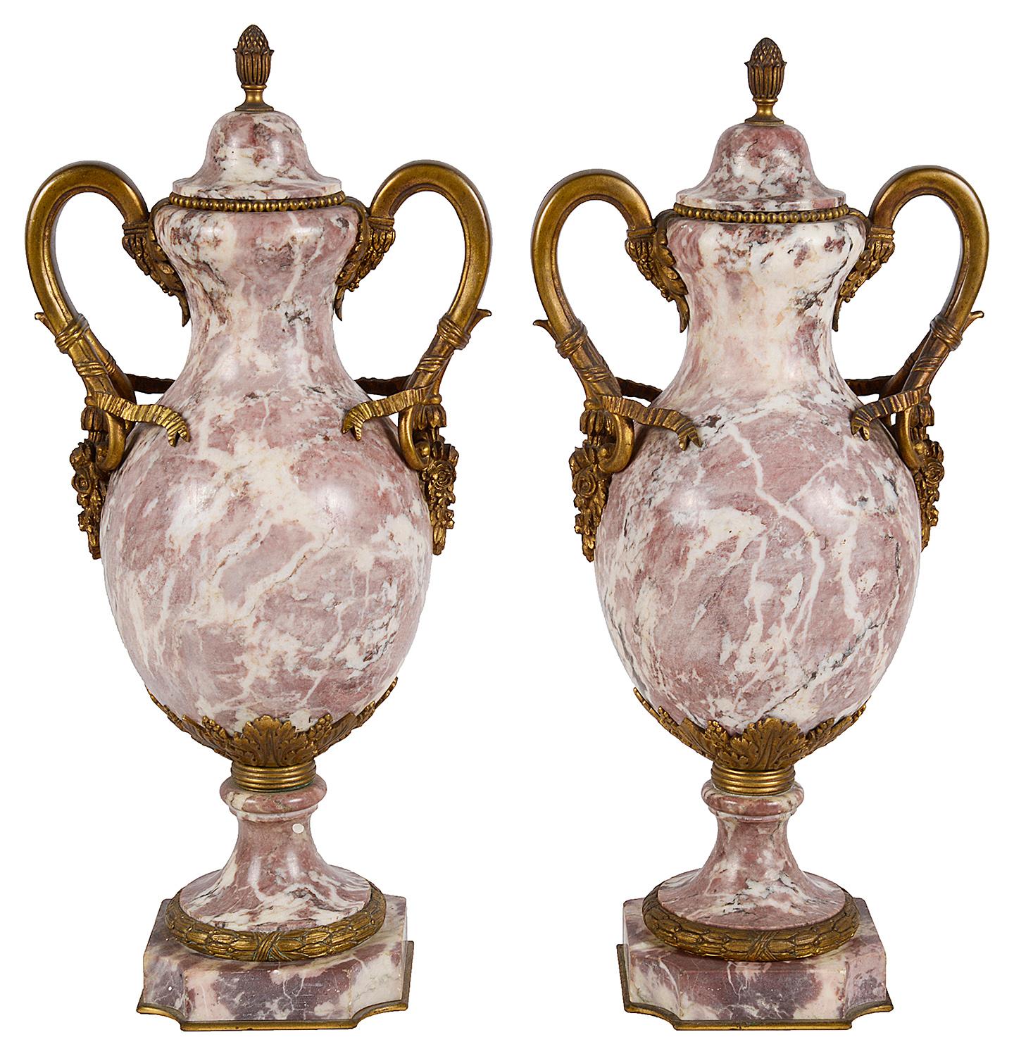 A good quality pair of 19th century French Breccia marble lidded urns, having wonderful figuring, gilded ormolu scrolling ribbon and floral decoration and raised on pedestal bases. Measures: 19