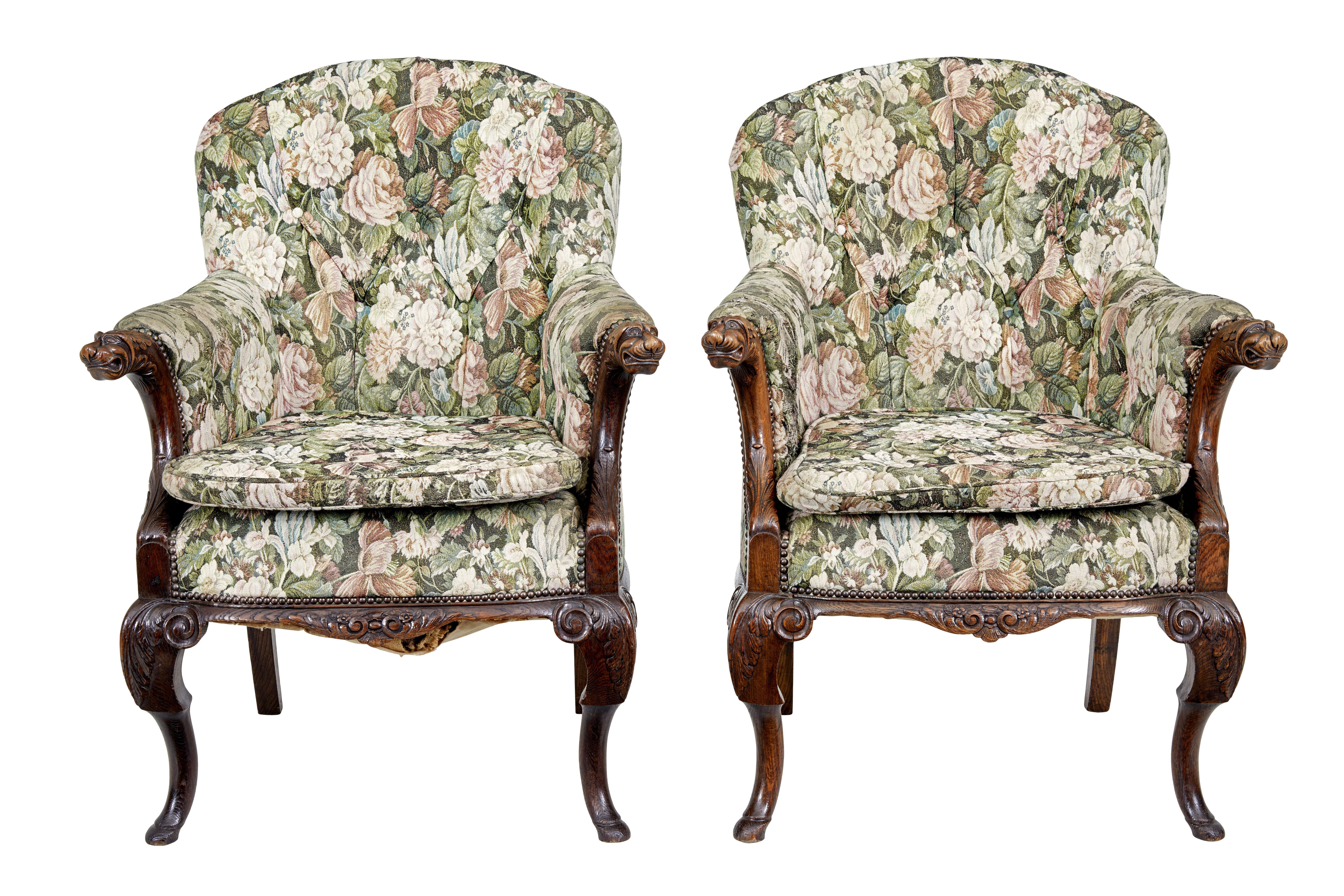 Pair of french 19th century carved oak armchairs circa 1870.

Fine quality pair of profusely carved armchairs.  Shaped backs with upholstered arms and a extra seat pad for added comfort.

Carved dogs and acanthus leaves to arms, further carving to