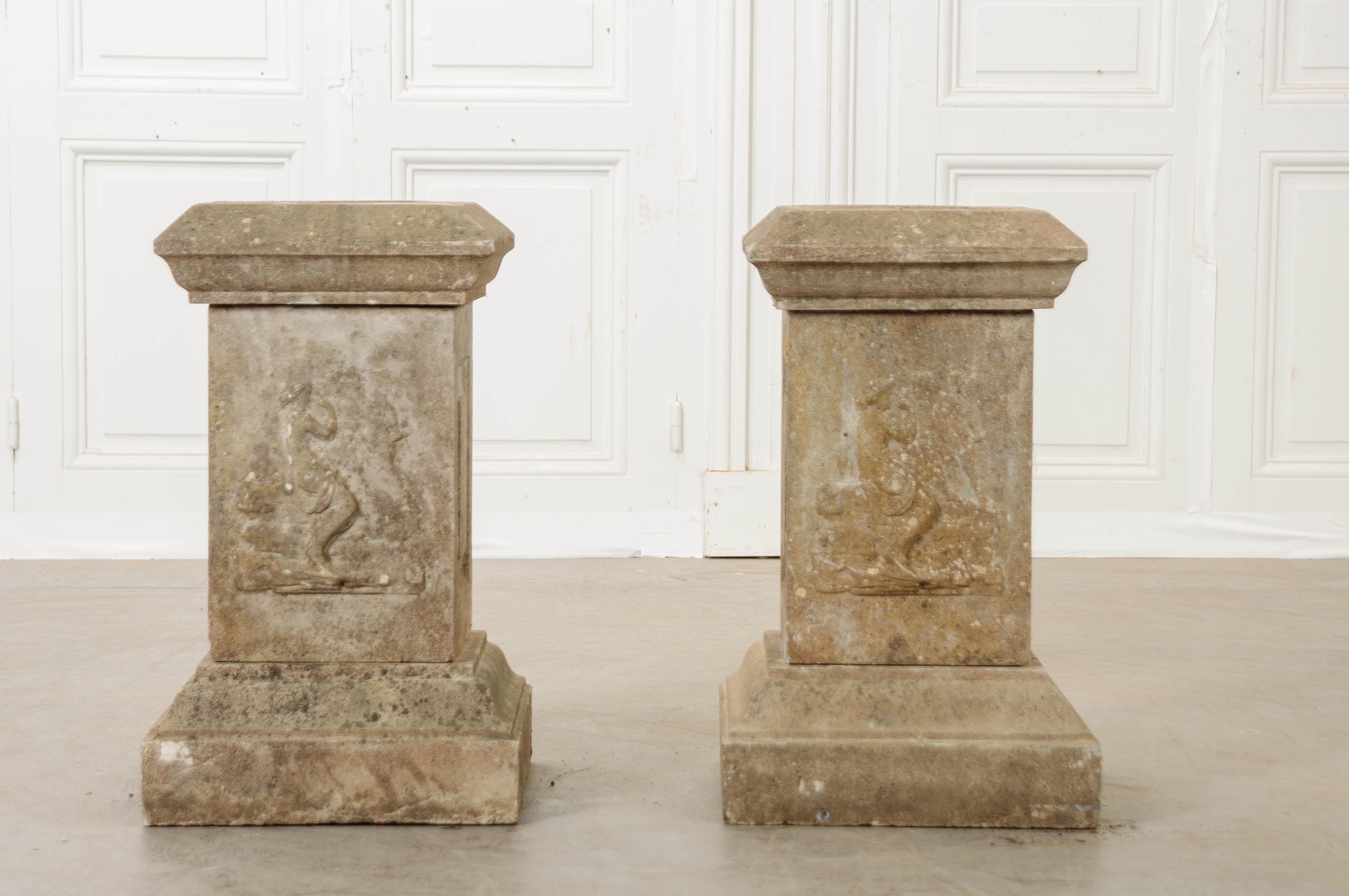 A pair of urn-form planters rest upon a pair of pedestals to complete this duo of superb garden antiques. Made in France, circa 1890, the planters are cast in a classical form and each have a drain to accommodate watering. The beautiful urns are