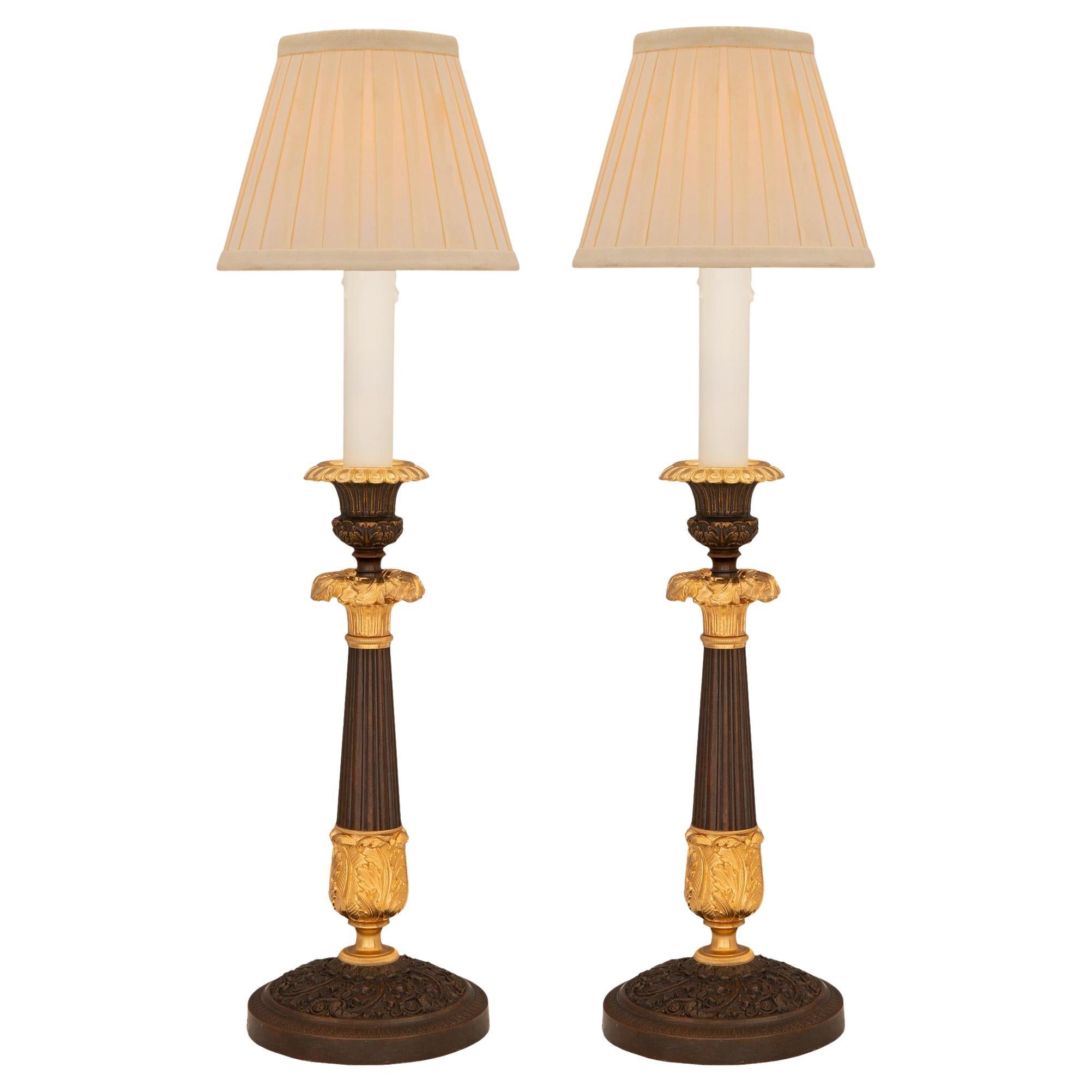 Pair of French 19th Century Charles X St. Bronze and Ormolu Candlestick Lamps For Sale