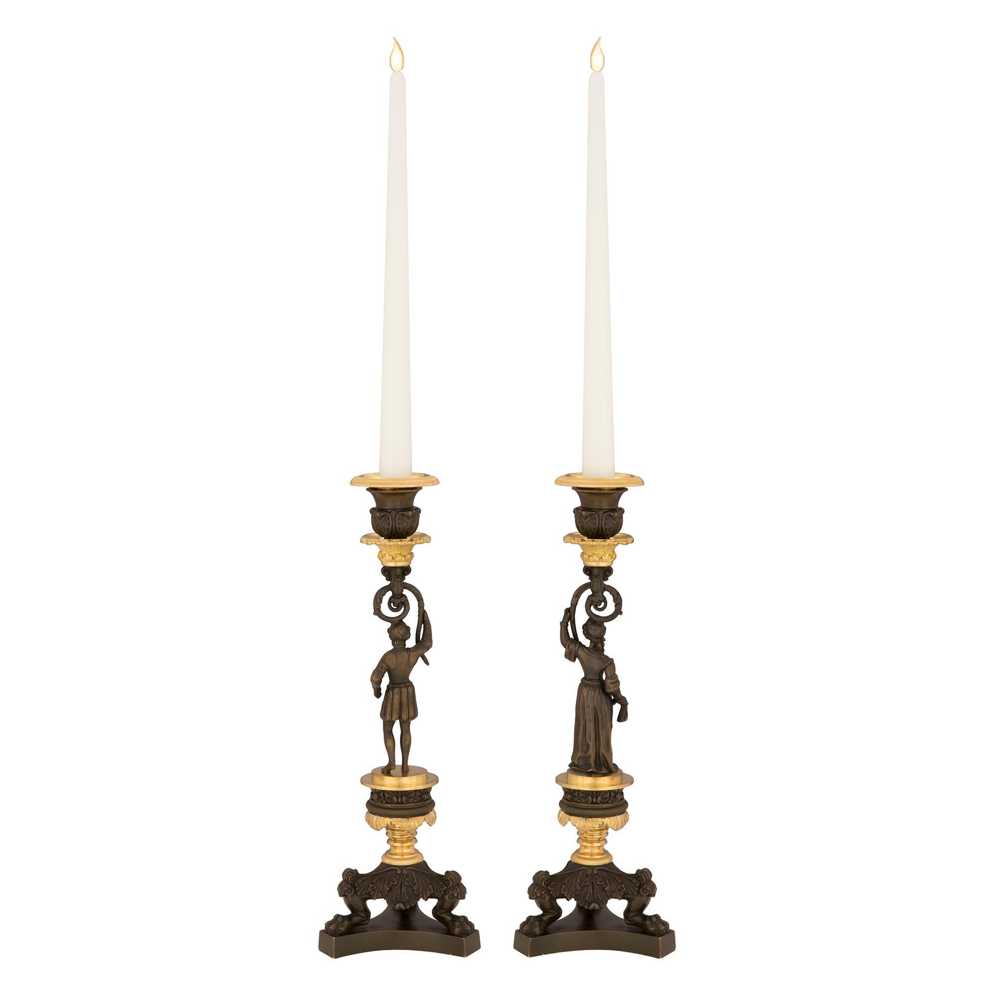 Patinated Pair of French 19th Century Charles X Style Bronze and Ormolu Candlesticks For Sale