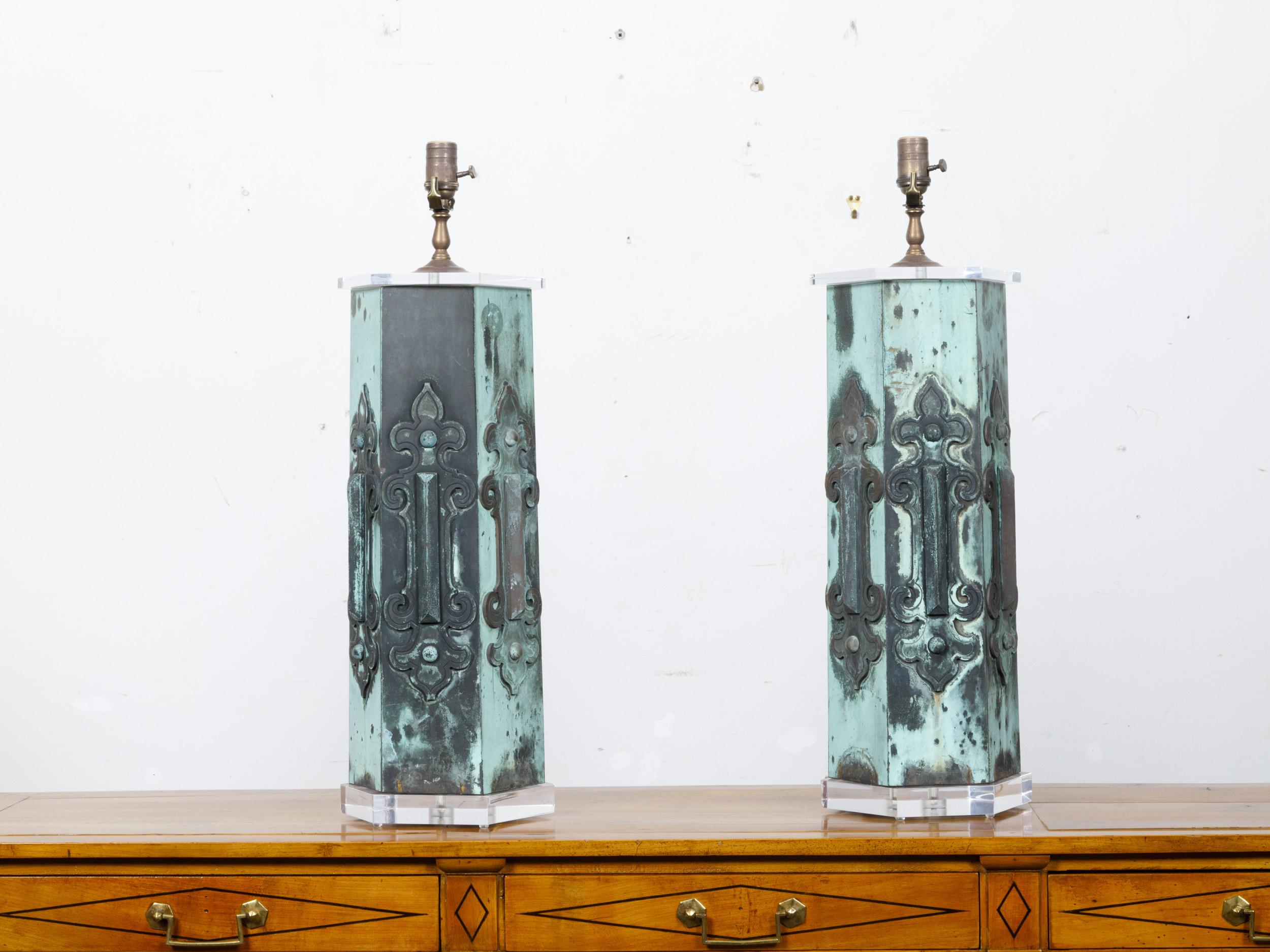 A pair of French hexagonal copper architectural elements from the 19th century with verdigris patina, made into table lamps on lucite bases, wired for the USA. This distinctive pair of table lamps combines the rustic elegance of 19th-century French