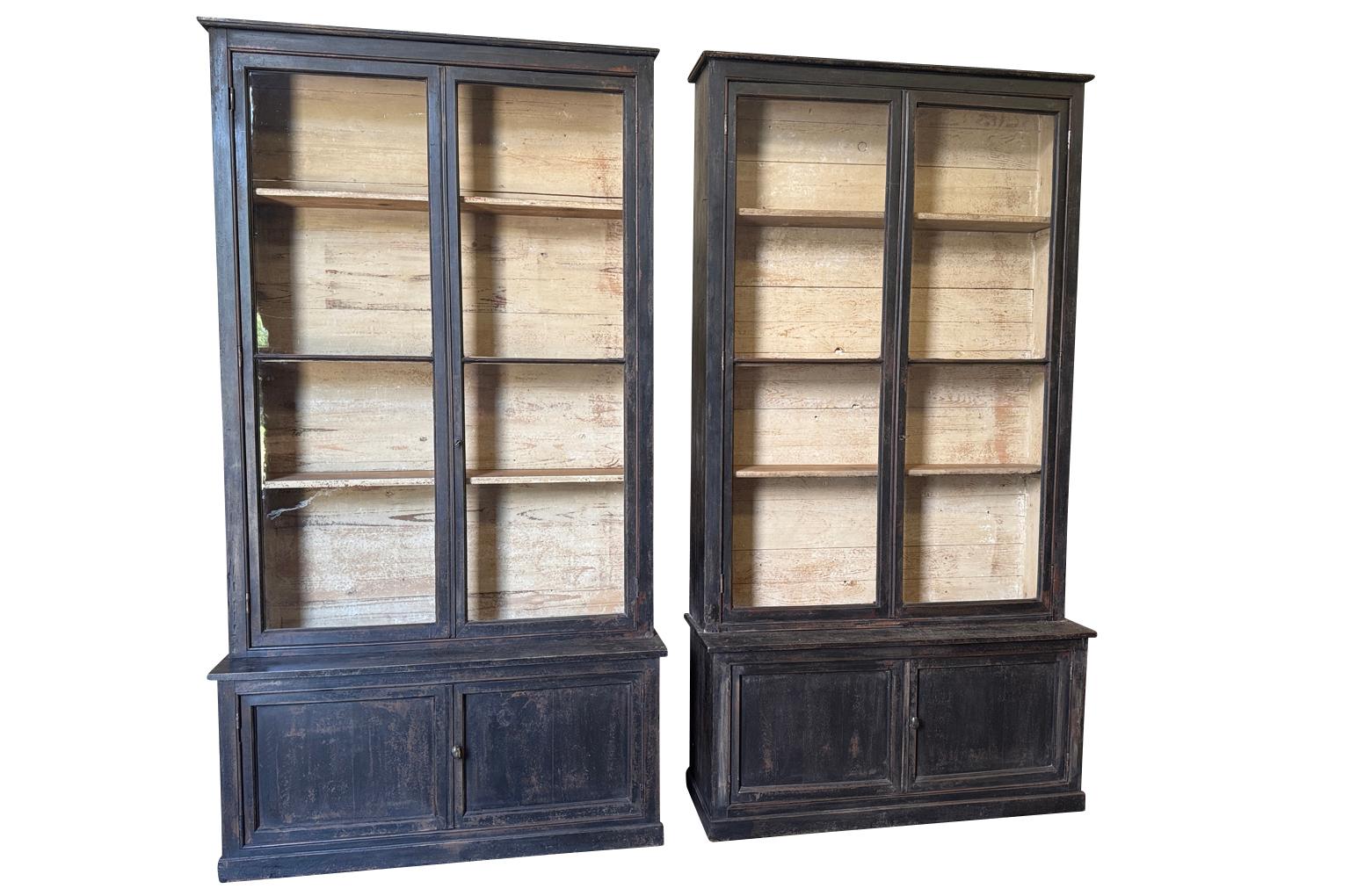 A very handsome pair of 19th century Deux Corps Bibliotheques from the Provence region of France in painted wood.  Wonderful storage and display cabinets. 