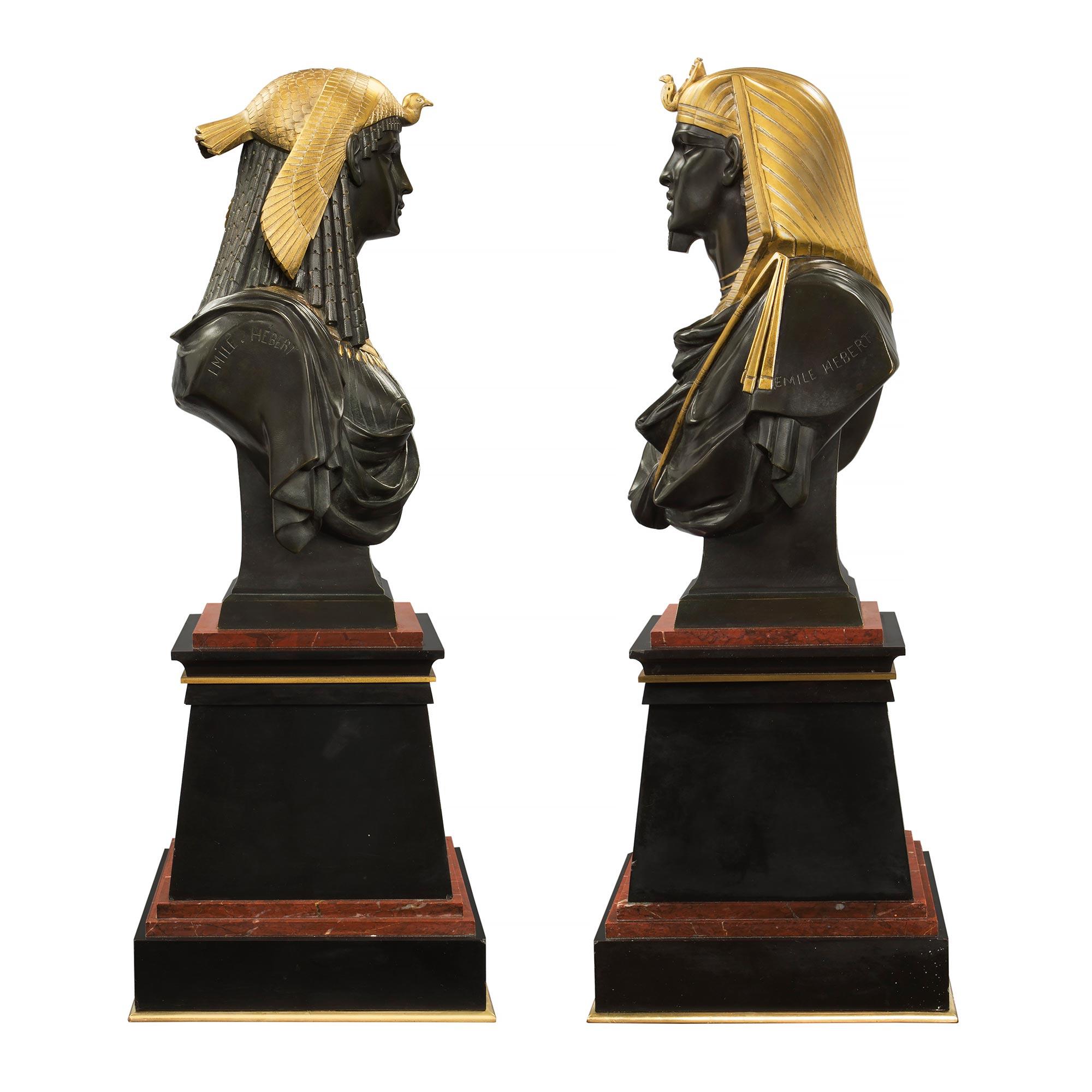 A very handsome pair of French 19th century Egyptian Revival st. busts of Ramses the II and his wife Isis, signed by Pierre-Eugène-Émile Hébert. Each is raised on a black Belgian marble base with ormolu trim and etched eagle design on the front,