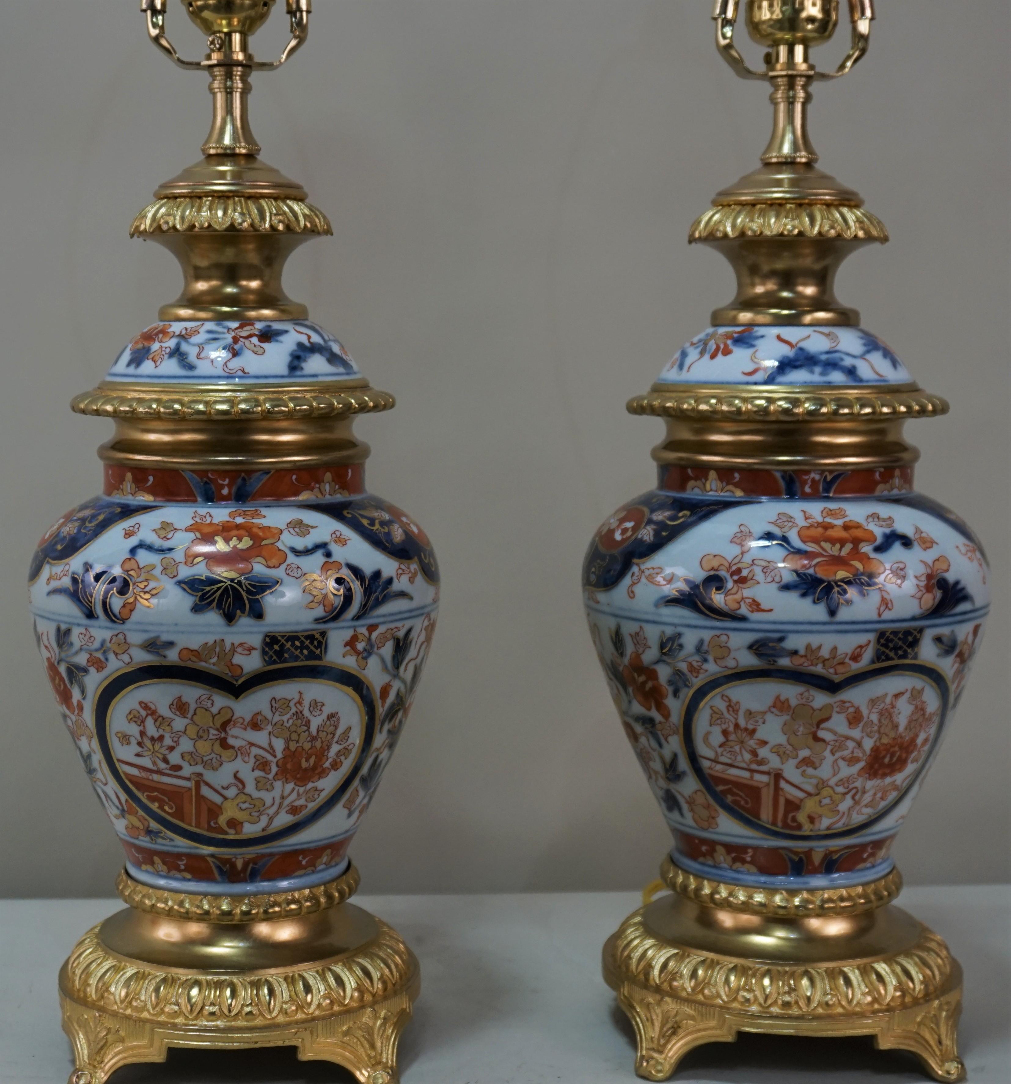 Pair of Japanese porcelain with bronze doré mounting table lamps. Professionally electrified and fitted with silk lampshades.